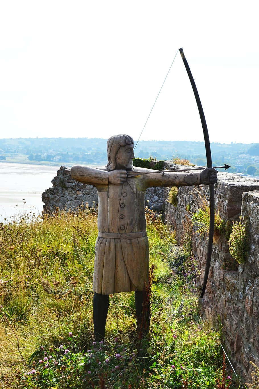 Mont Orgueil Castle, wooden archer statue, grassy cliffside, HD Phone Wallpaper