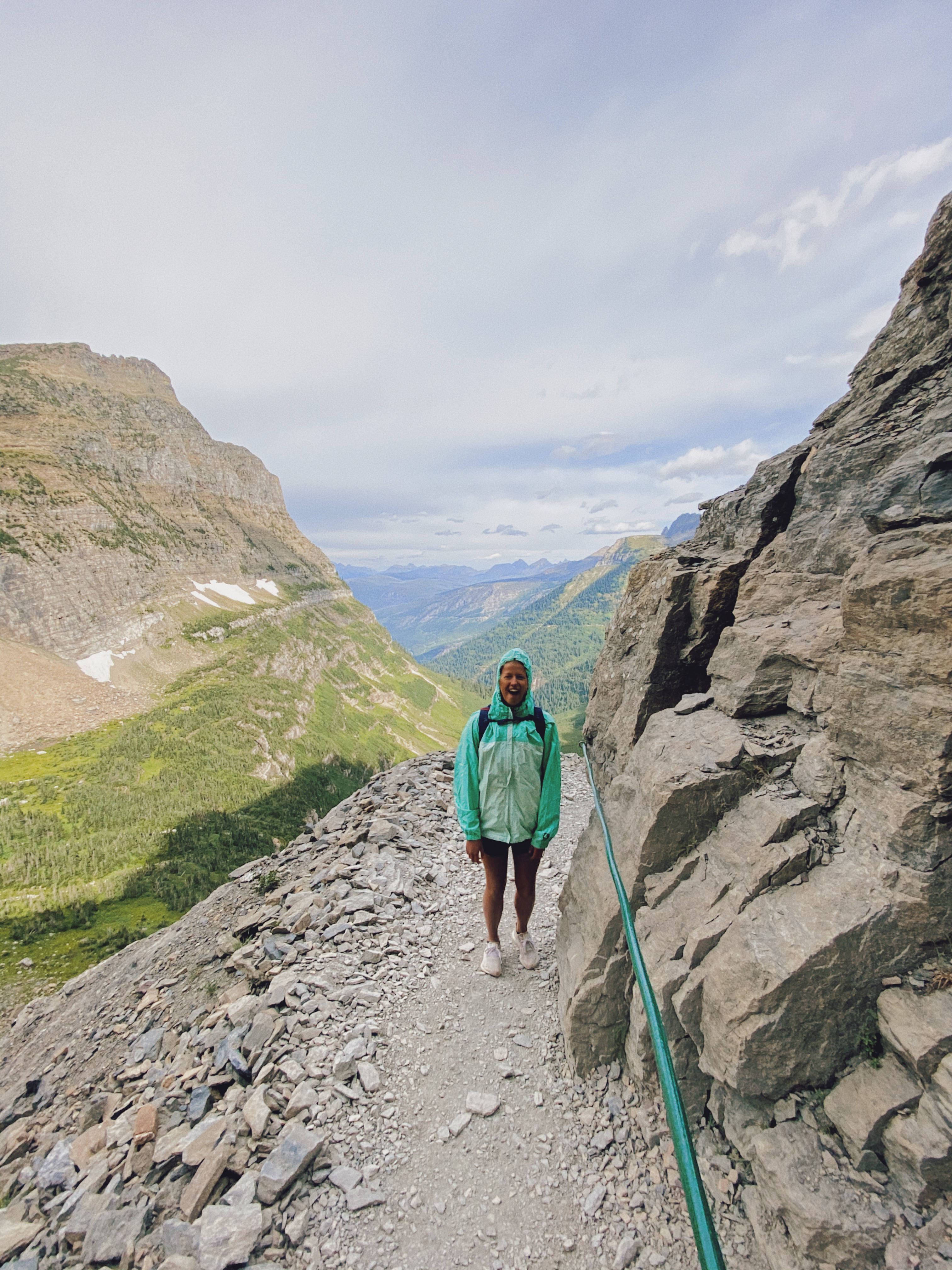 female hiker, teal jacket, rocky mountain trail, 4K Phone Wallpaper
