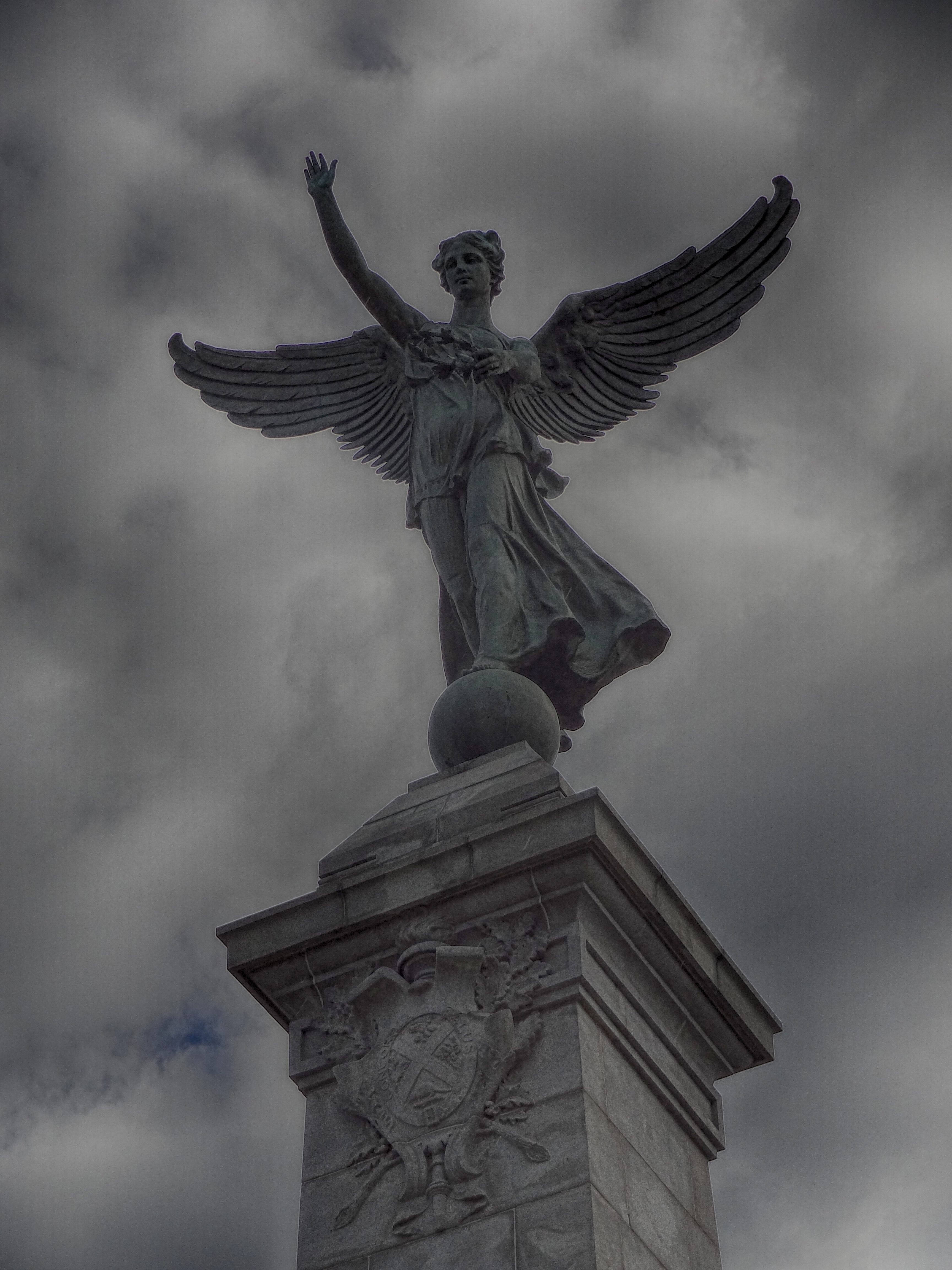 winged angel statue, stone pedestal, cloudy sky, 4K Phone Wallpaper