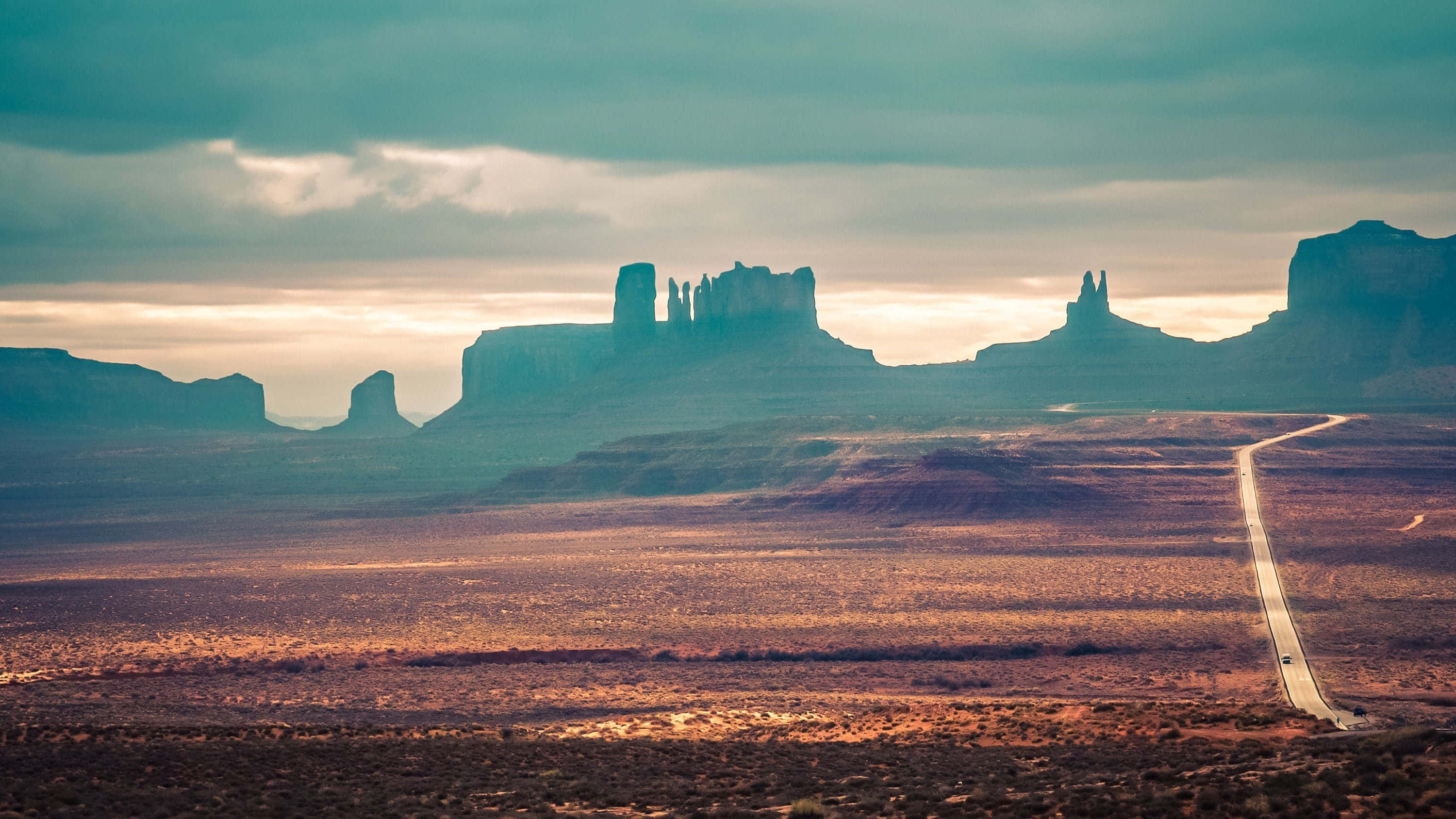 Monument Valley Navajo Tribal Park, red rock buttes, twilight sky, 2K Desktop Wallpaper