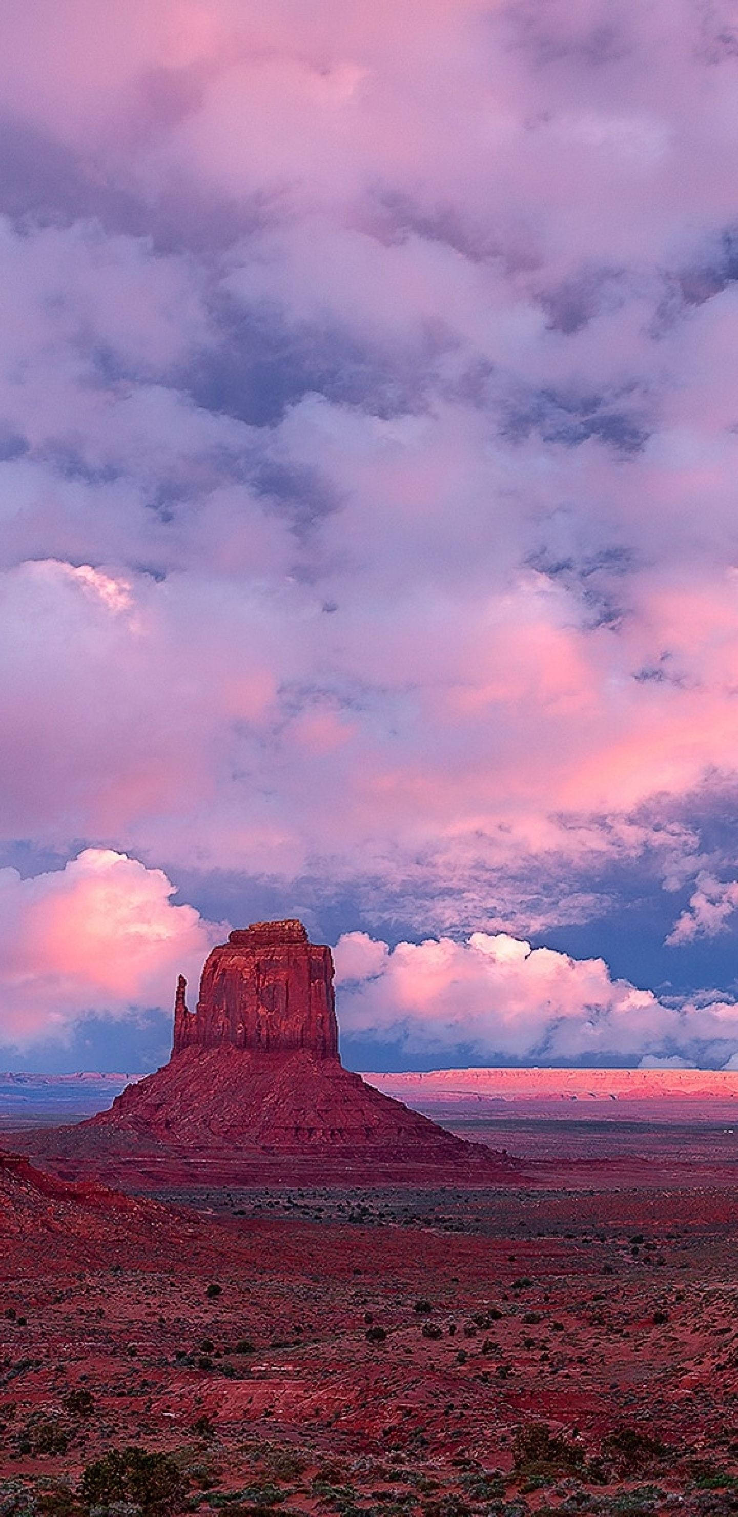 Monument Valley, red rock butte, pink and purple sunset sky, 2K Phone Wallpaper
