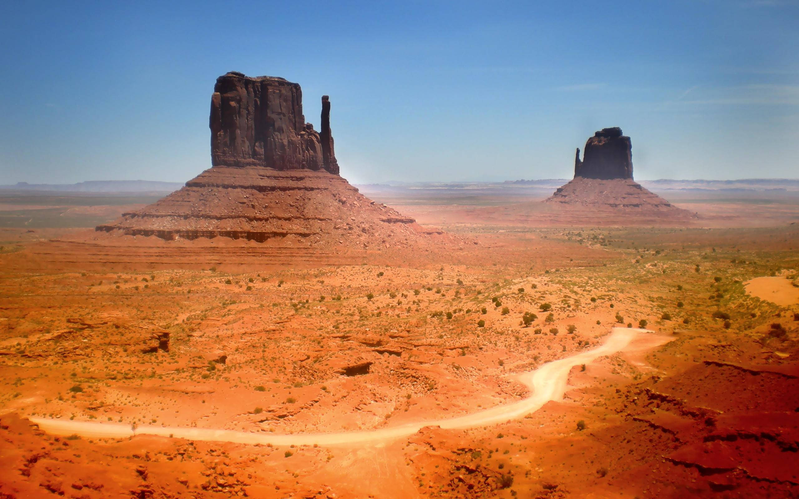 Monument Valley, black mountain rocks, red desert landscape, 2K Desktop Wallpaper