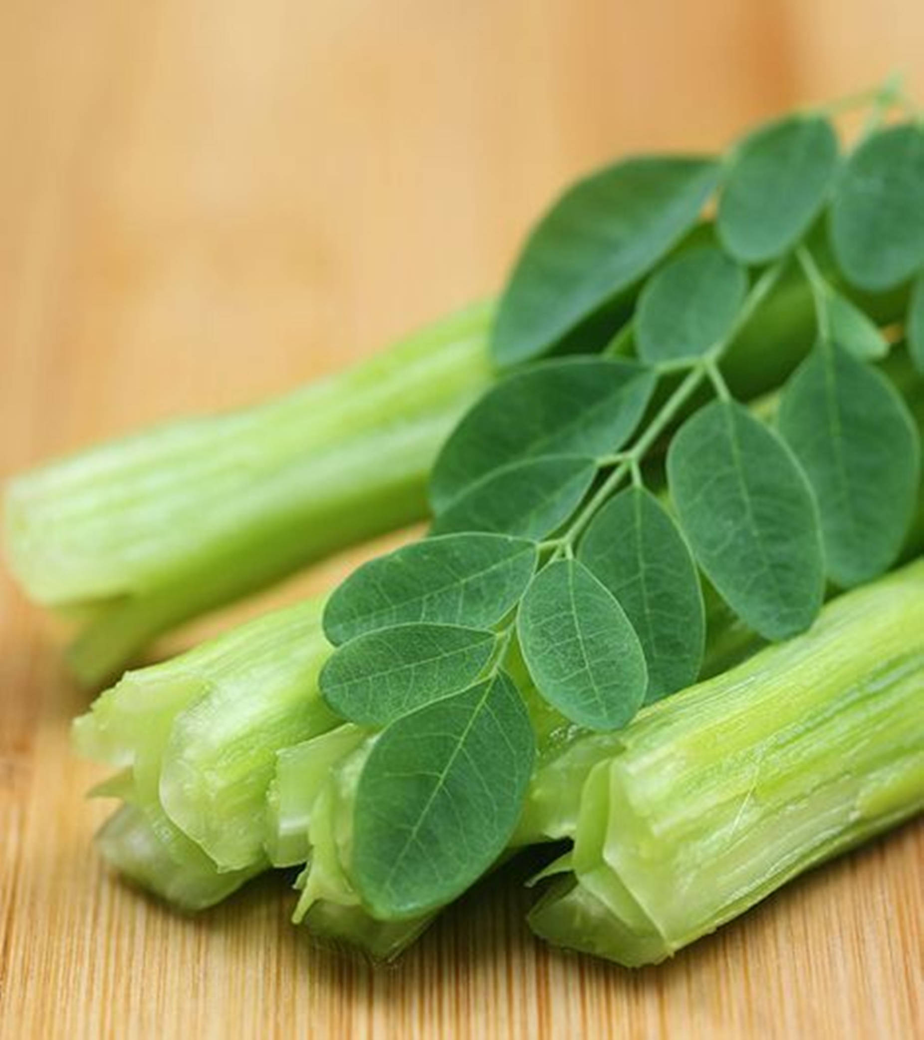moringa leaves, moringa stems, warm wooden surface, Full HD Phone Wallpaper