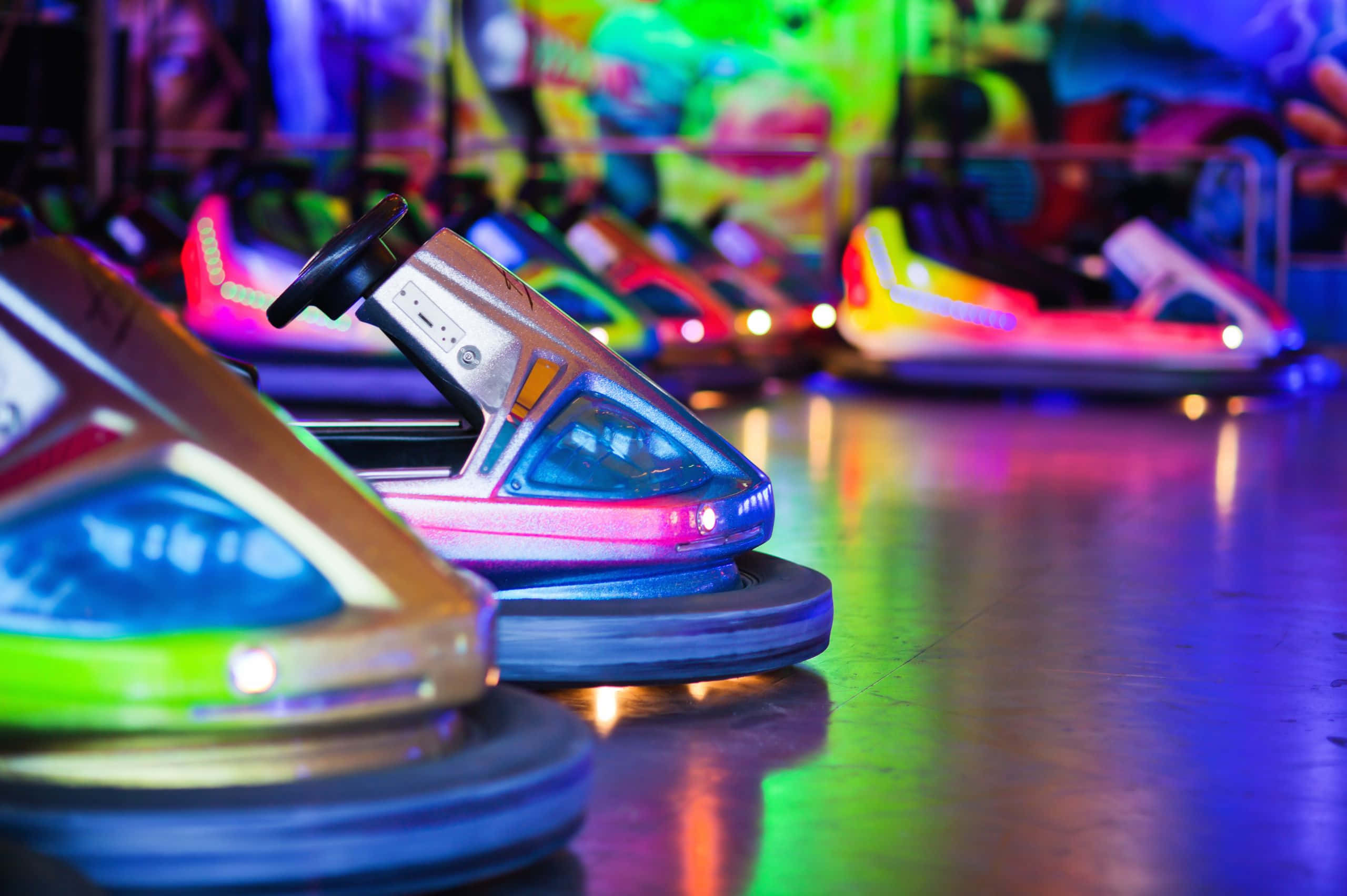 neon-lit bumper cars, reflective floor, bustling amusement arcade, 2K Desktop Wallpaper