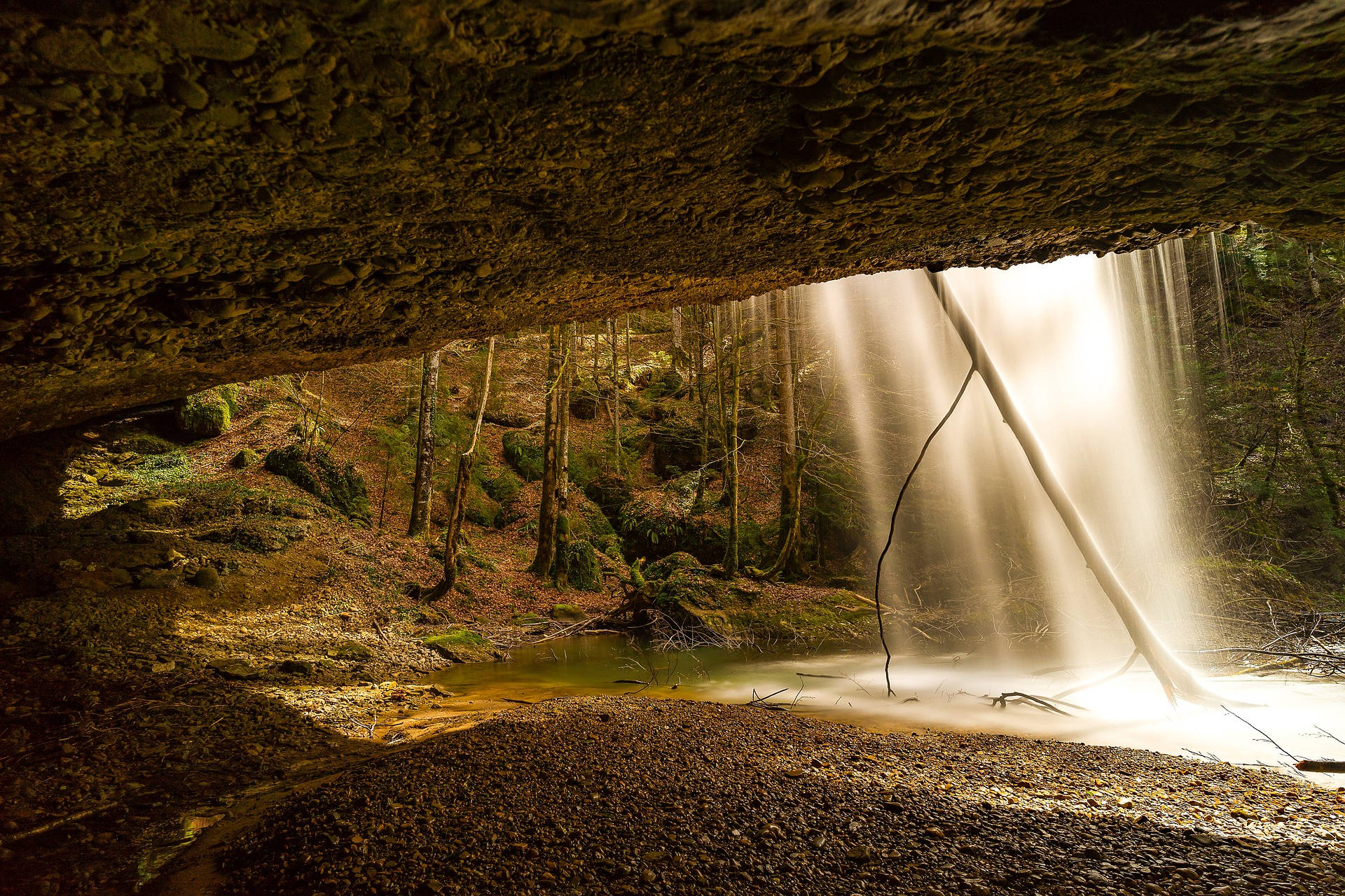 shimmering waterfall, forested cave opening, golden light, Full HD Desktop Wallpaper