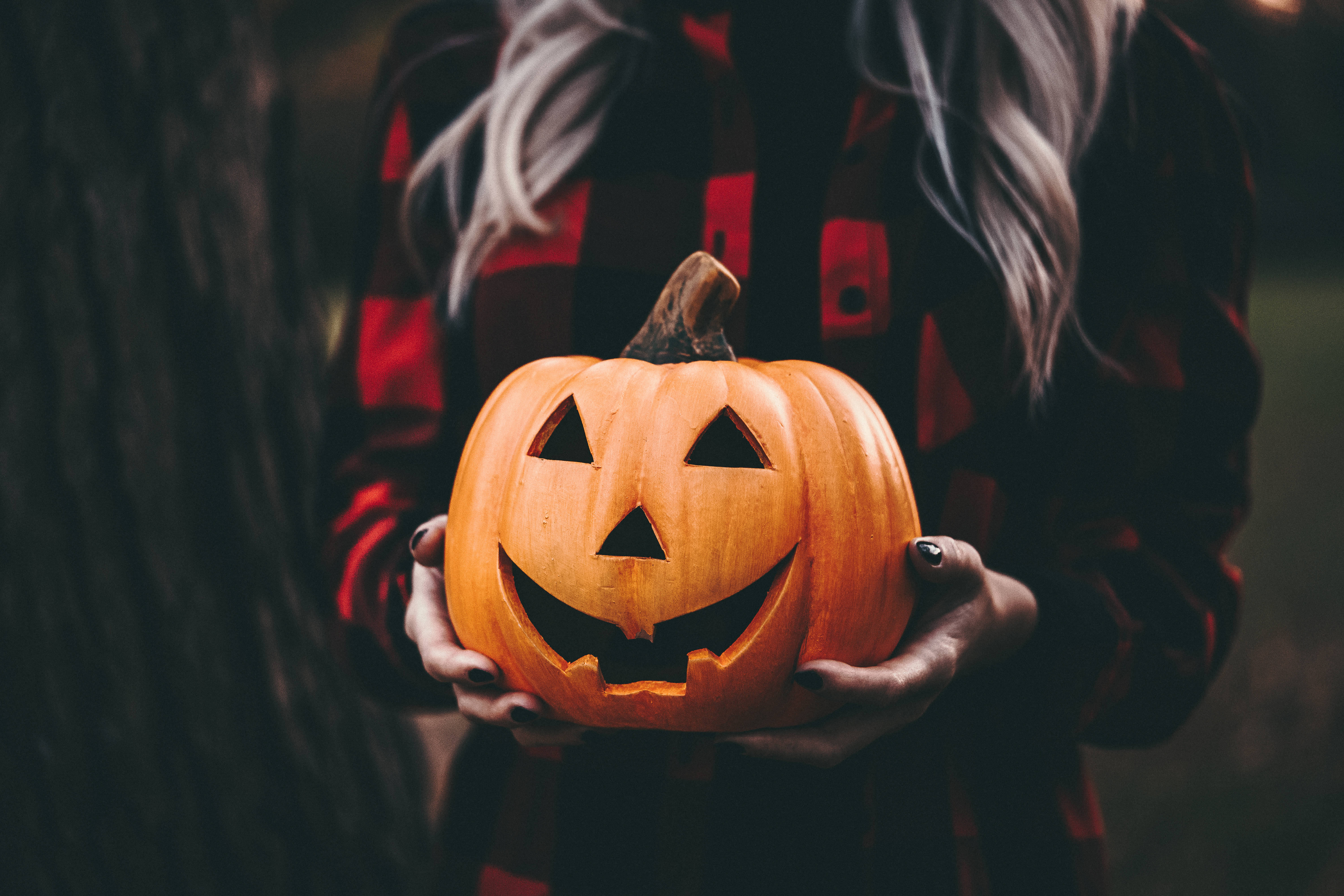 red plaid shirt, carved orange jack-o'-lantern, glowing face, 5K Desktop Wallpaper