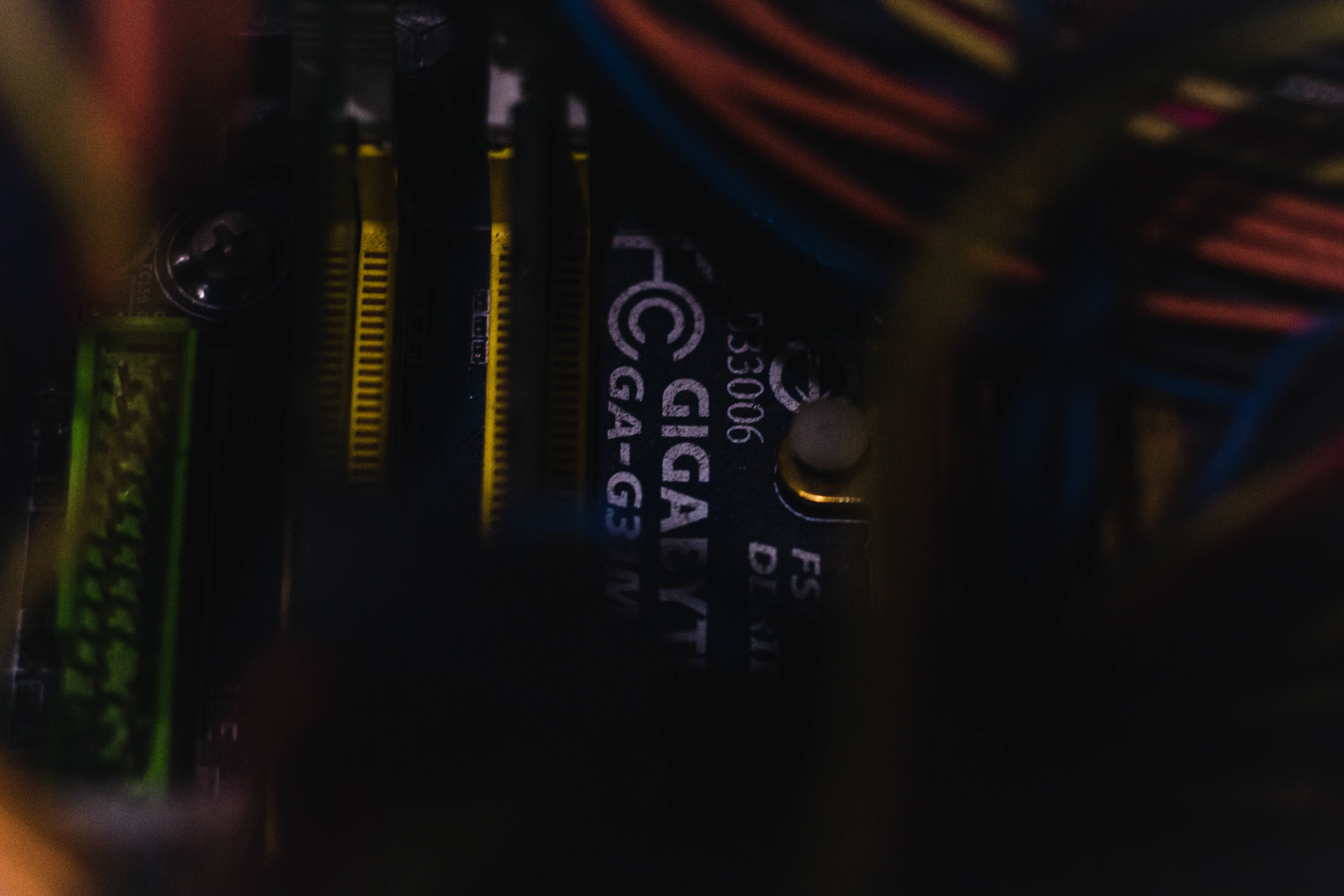 futuristic motherboard, glowing green components, colorful cables, 5K Desktop Wallpaper