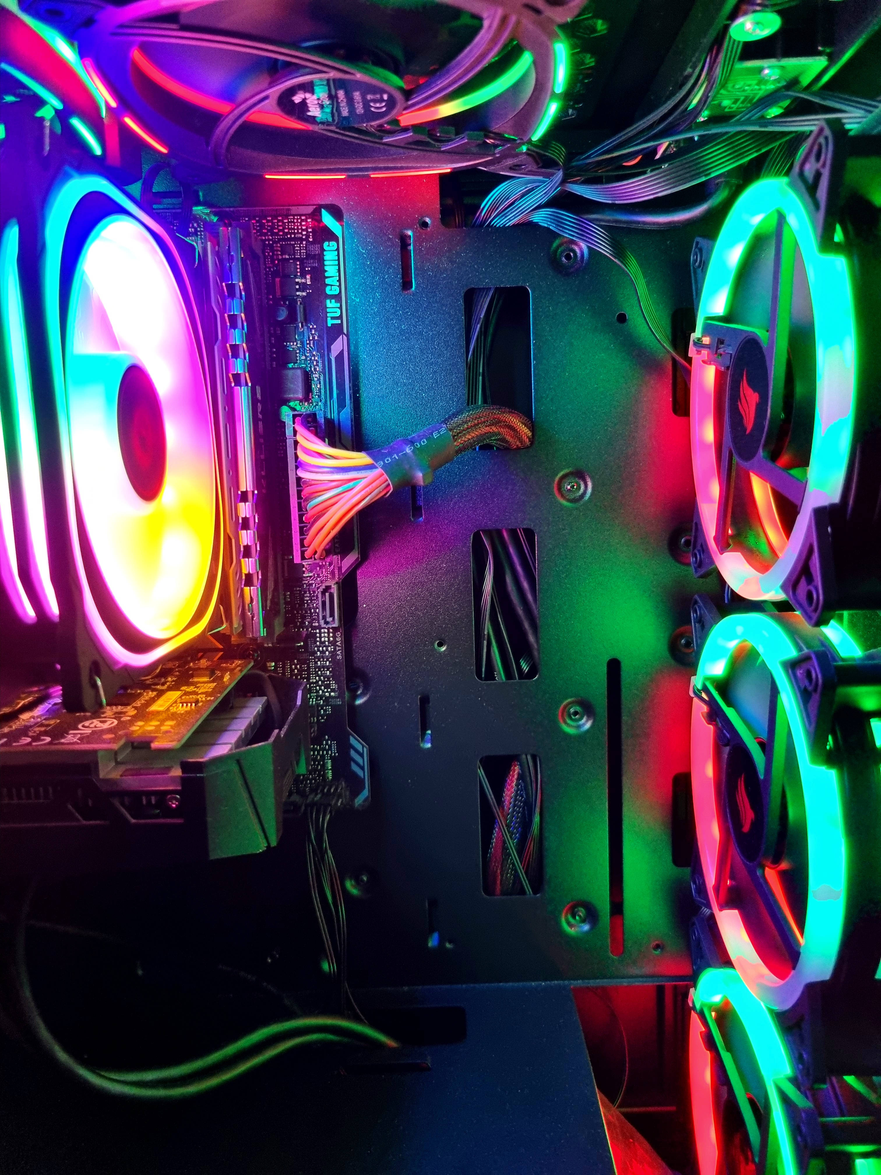 modern detailed motherboard, high-performance gaming PC case, vibrant rainbow LED lights, 4K Phone Wallpaper
