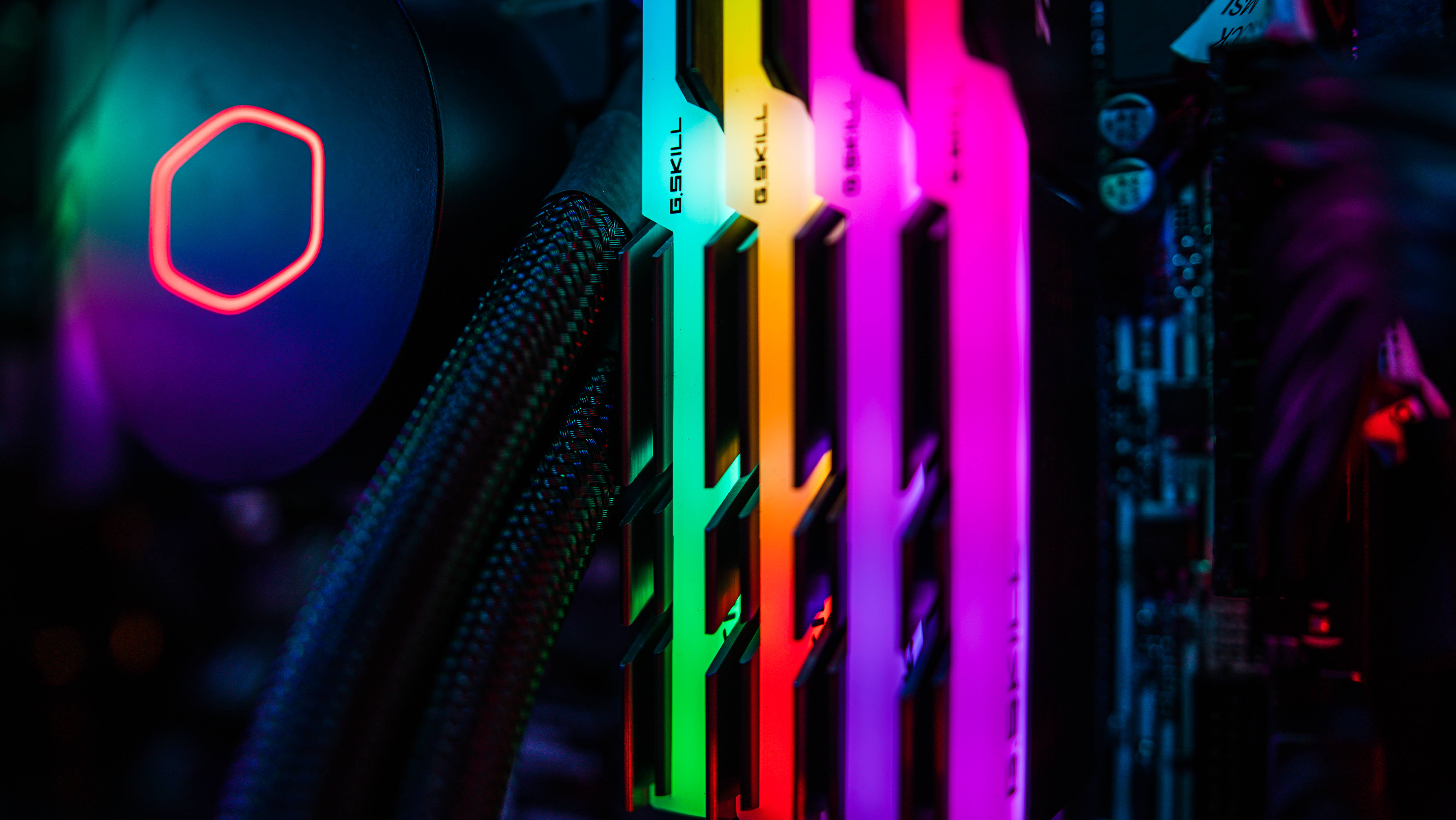 modern motherboard, rainbow LED-lit RAM sticks, glowing CPU cooler, 5K Desktop Wallpaper