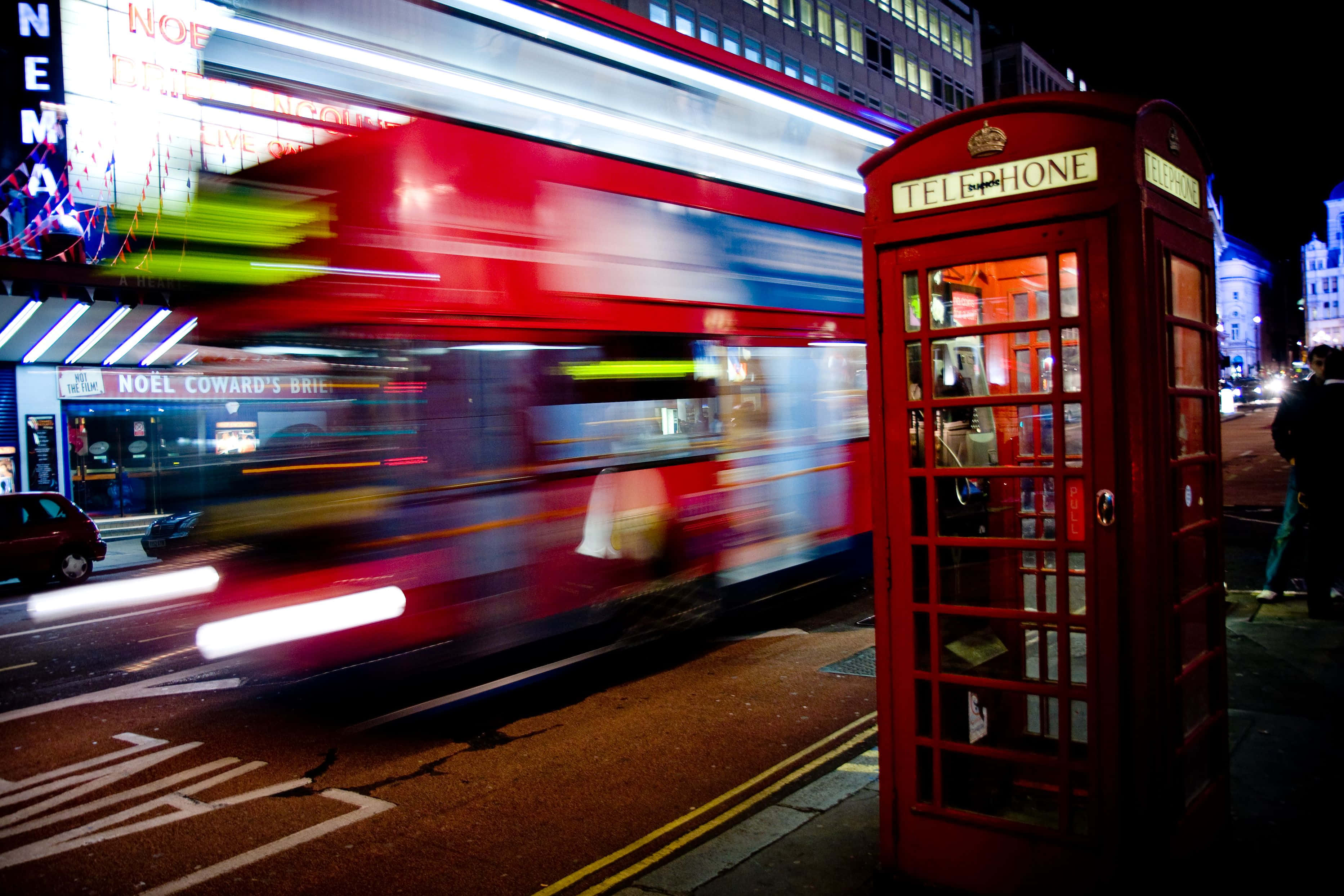 red London phone booth, blurred double-decker bus, neon lights, 2K Desktop Wallpaper