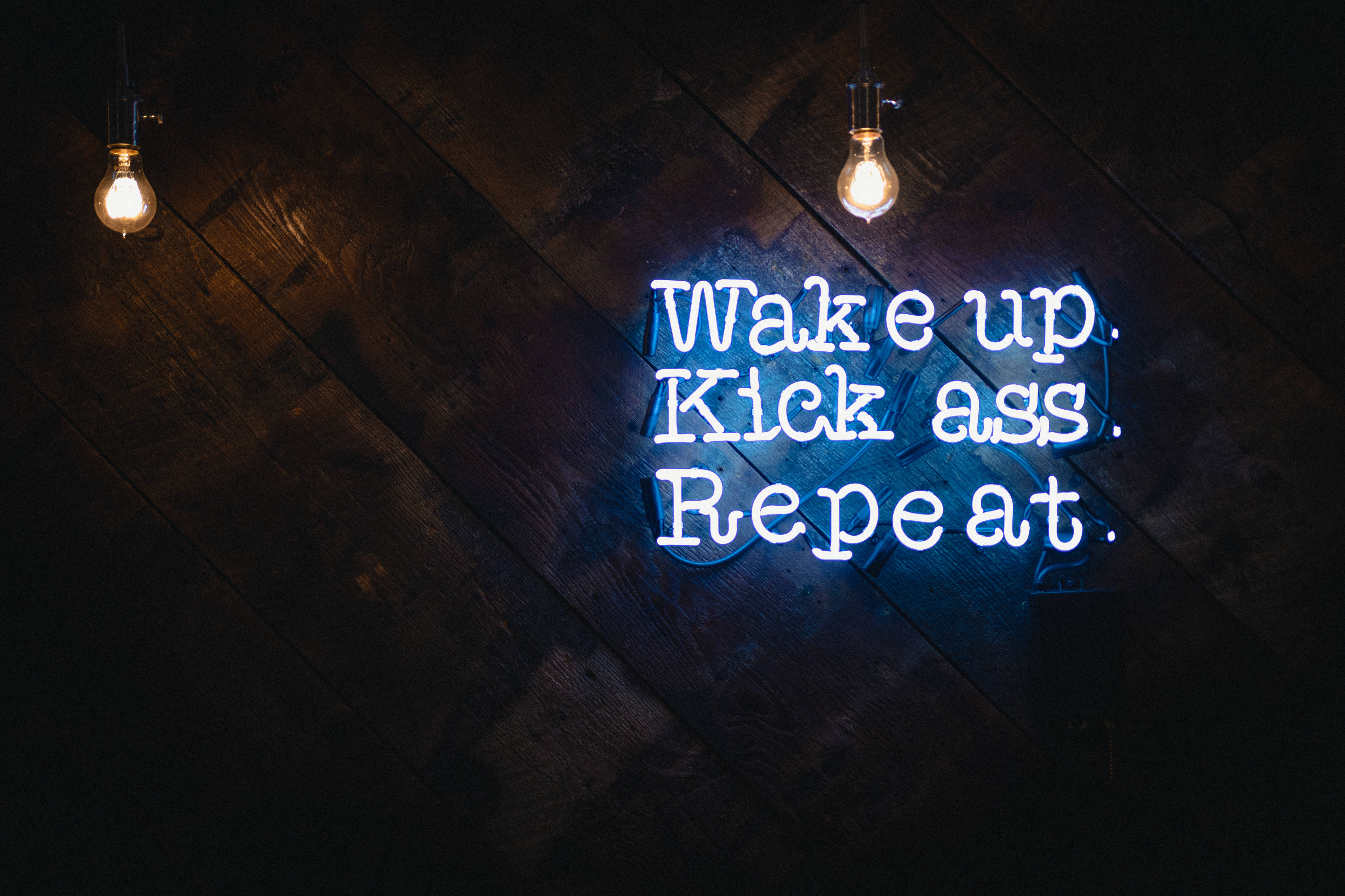 glowing blue neon sign, Wake up. Kick ass. Repeat., dark wooden wall, 5K Desktop Wallpaper