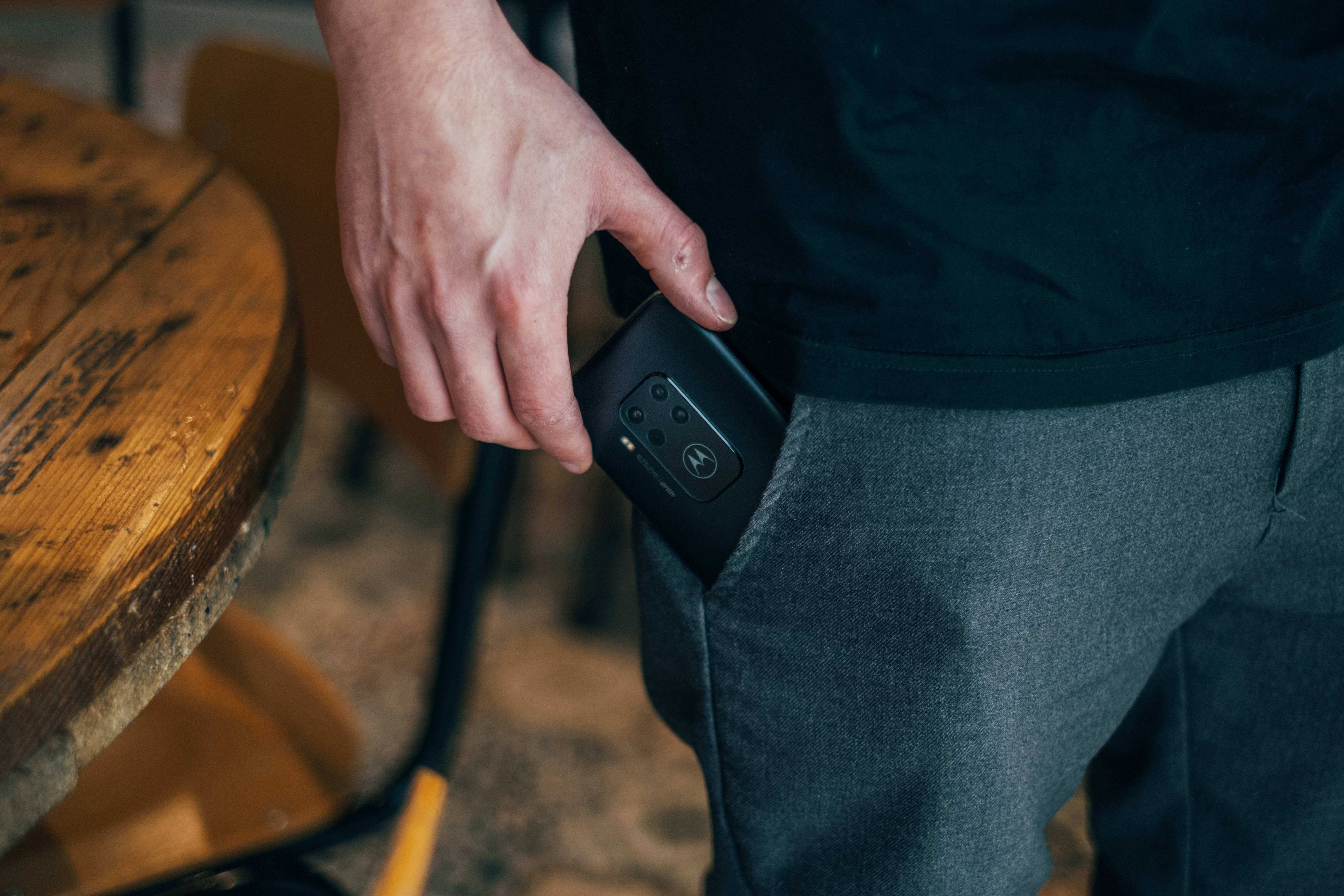 Motorola, black smartphone, gray pants, 5K Desktop Wallpaper