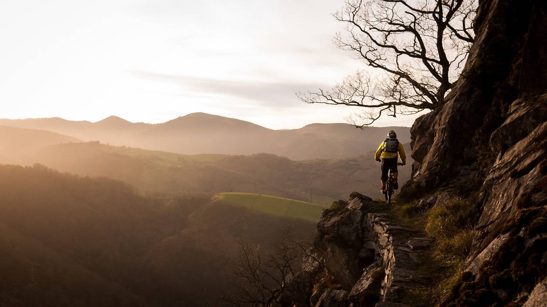 yellow jacket, rugged stone path, cliffside, HD Desktop Wallpaper