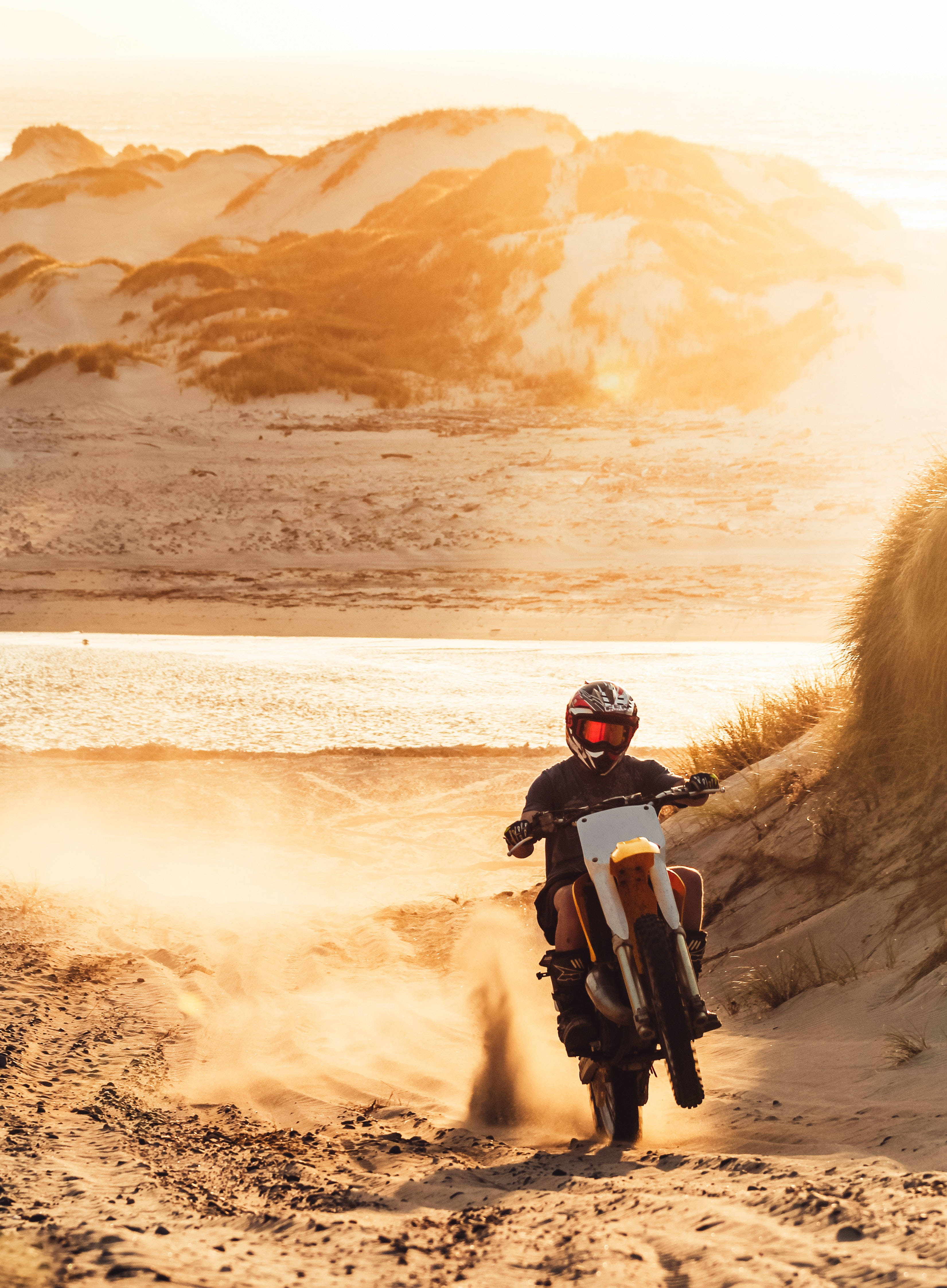 dirt bike, dusty mountain road, golden sunset, 4K Phone Wallpaper