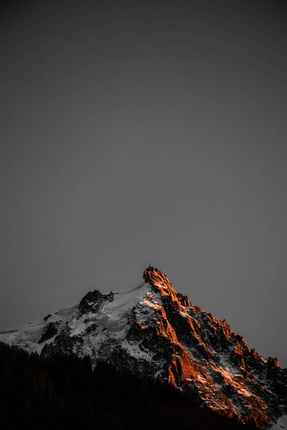 snowy mountain peak, warm golden light, dark gray sky, HD Phone Wallpaper