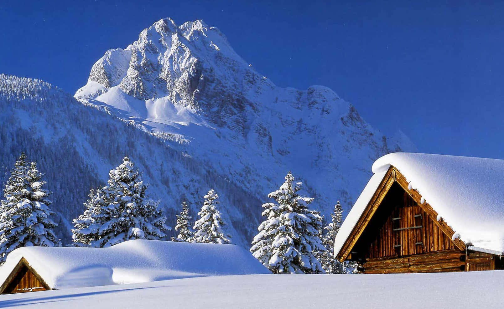 snow-covered wooden cabins, serene winter mountain valley, clear blue sky, HD Desktop Wallpaper