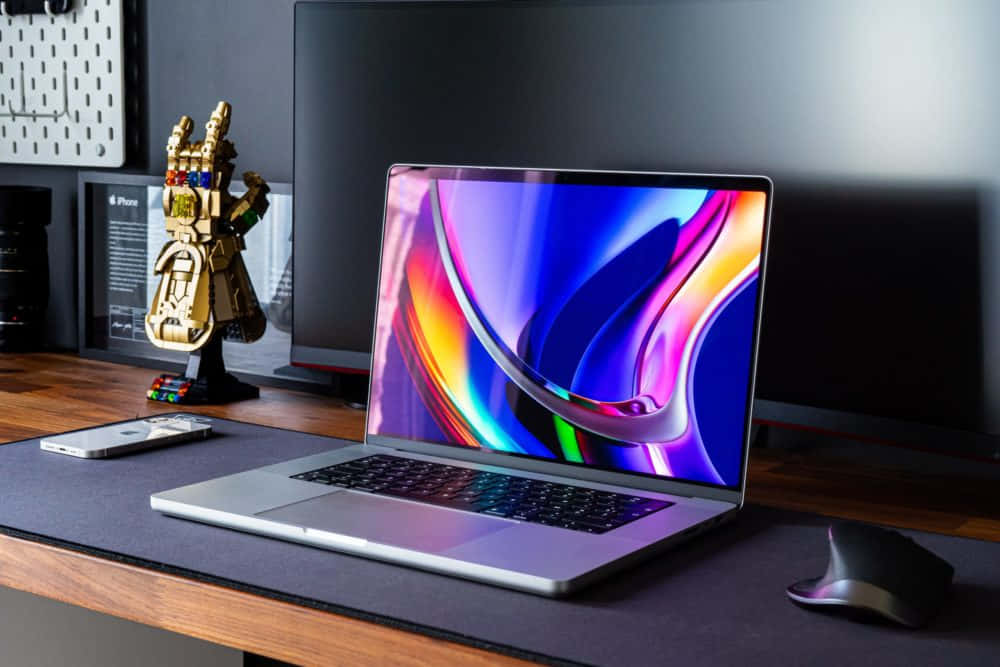 silver laptop, vibrant abstract wallpaper, wooden desk, SD Desktop Wallpaper