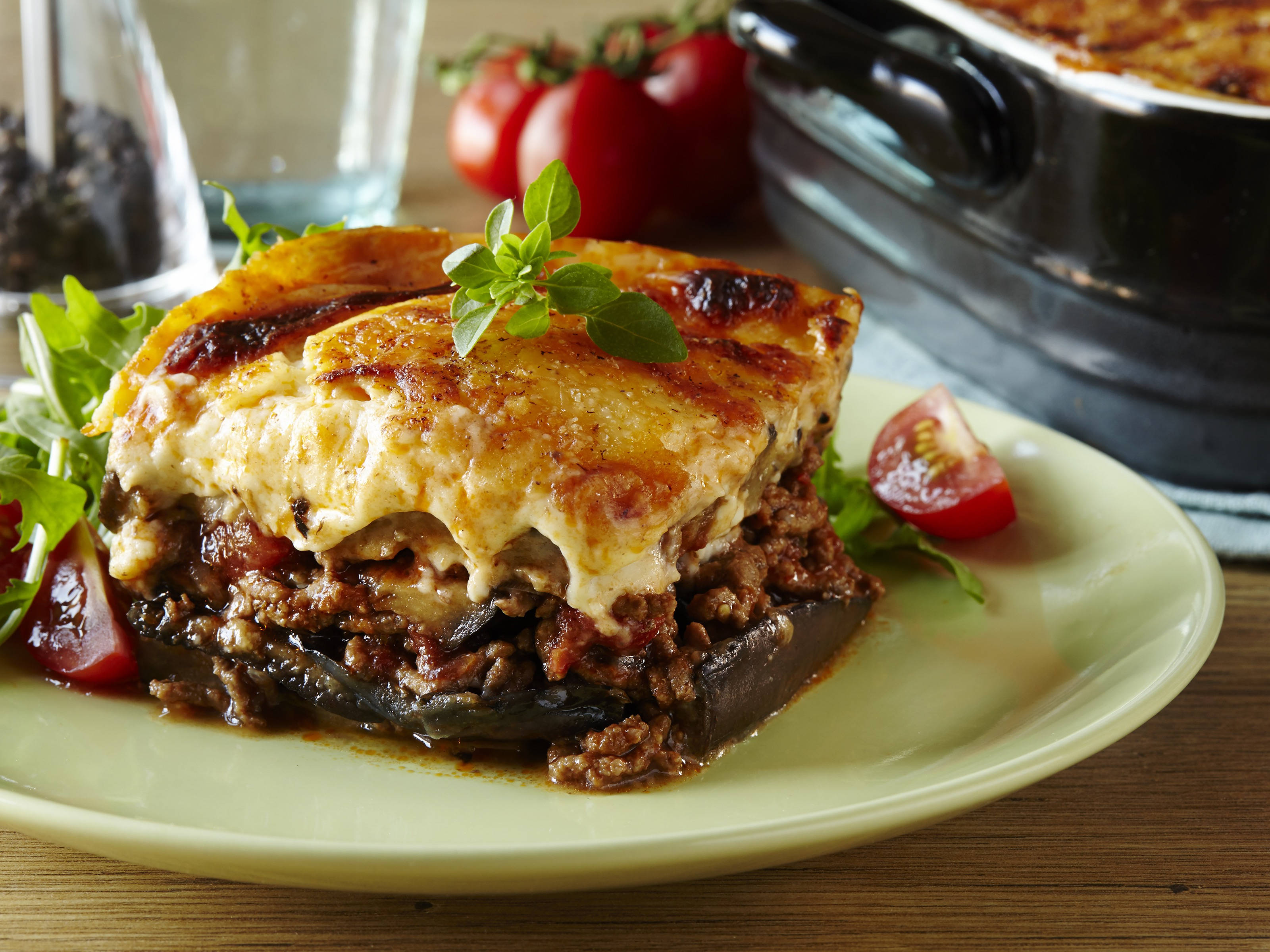 garnished velvety baked moussaka, golden-brown slice, melted cheese, 2K Desktop Wallpaper
