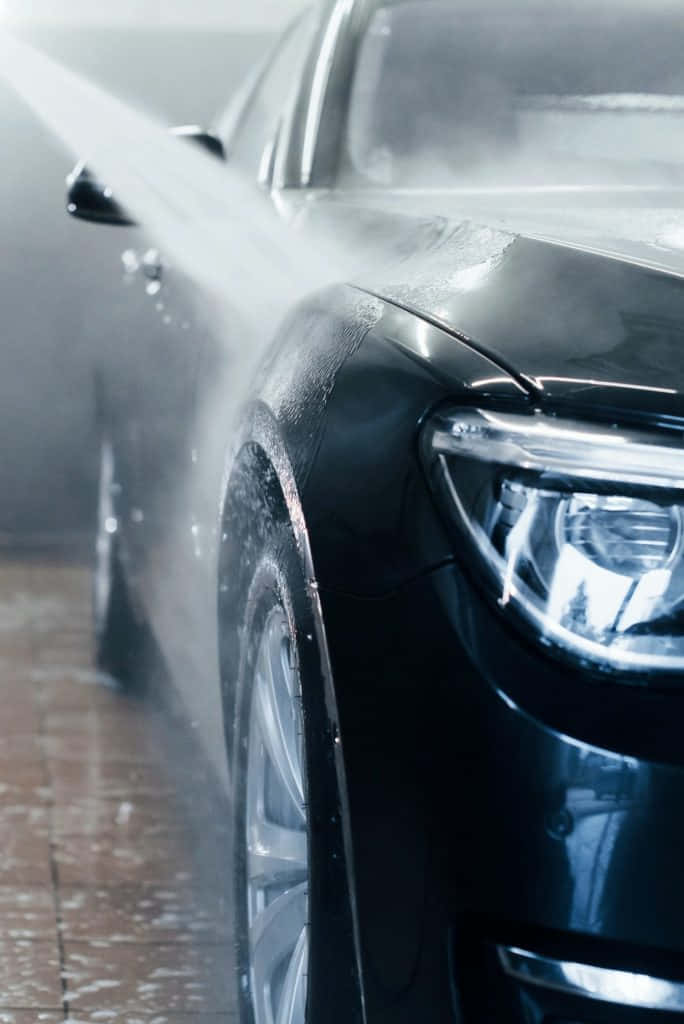 sleek black car, powerful water jets, misty car wash bay, SD Phone Wallpaper