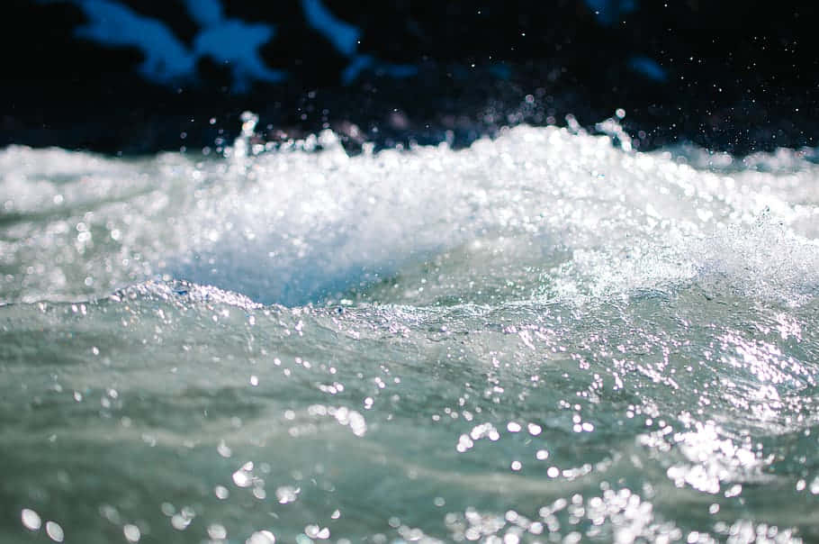 sunlit ocean waves, sparkling white foam, dark blue backdrop, SD Desktop Wallpaper