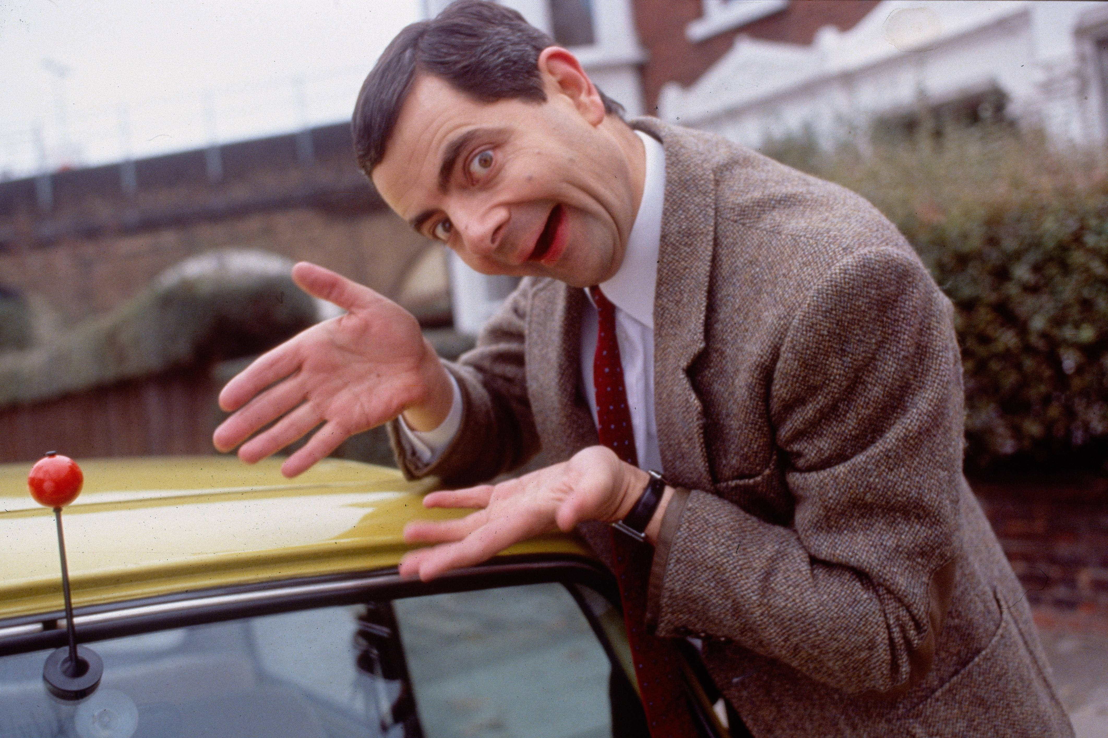 Mr Bean, yellow car, suburban setting, 4K Desktop Wallpaper