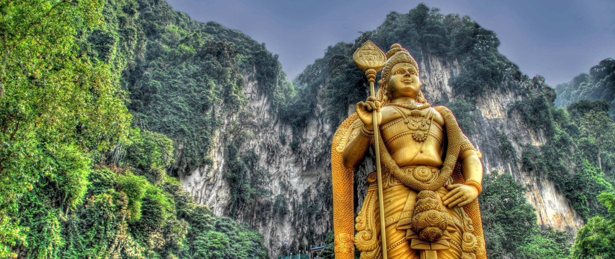 Murugan, golden statue, lush green cliffside, 2K Desktop Wallpaper
