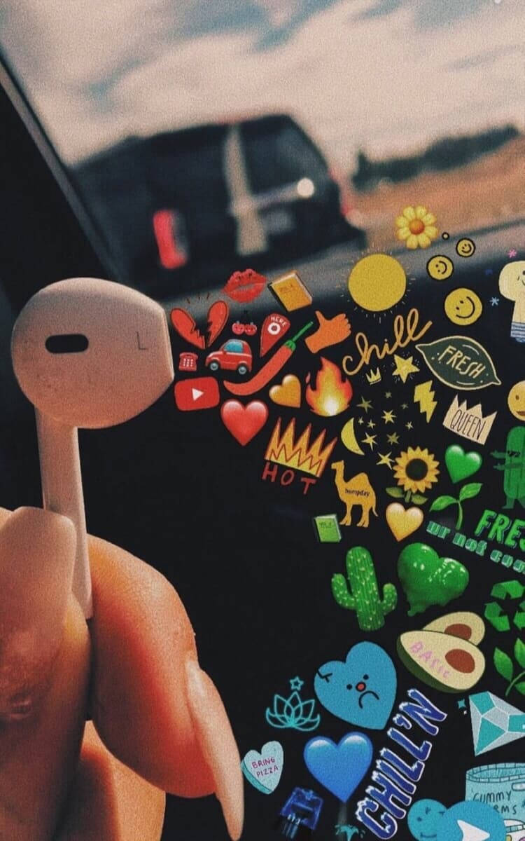 white earbud, phone covered in colorful stickers, blurred car window background, SD Phone Wallpaper
