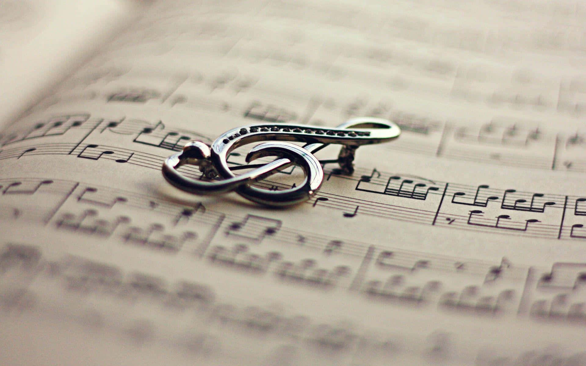 shiny silver treble clef brooch, vintage sheet music, soft warm lighting, Full HD Desktop Wallpaper
