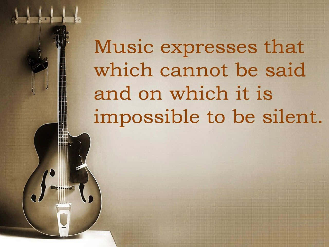 vintage archtop guitar, quote about music's power to express the unspeakable, warm sepia tones, HD Desktop Wallpaper