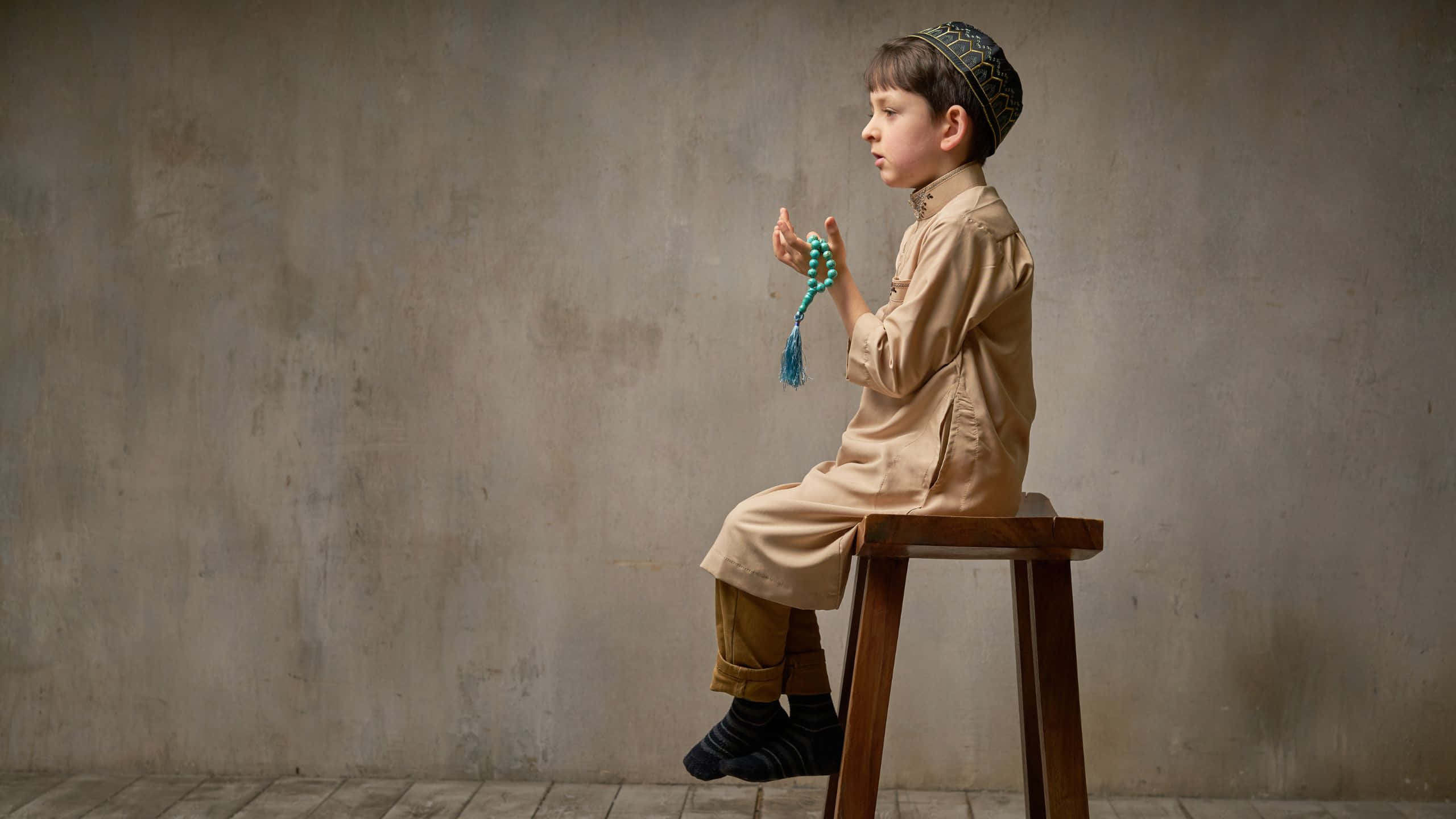 Muslim Boy, traditional attire, wooden stool, 2K Desktop Wallpaper
