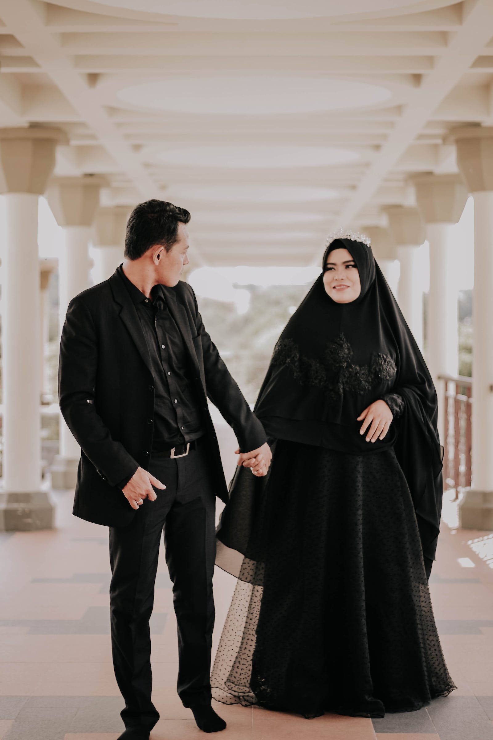 Muslim Couple Holding Hands, elegant black attire, bright white colonnaded structure, Full HD Phone Wallpaper