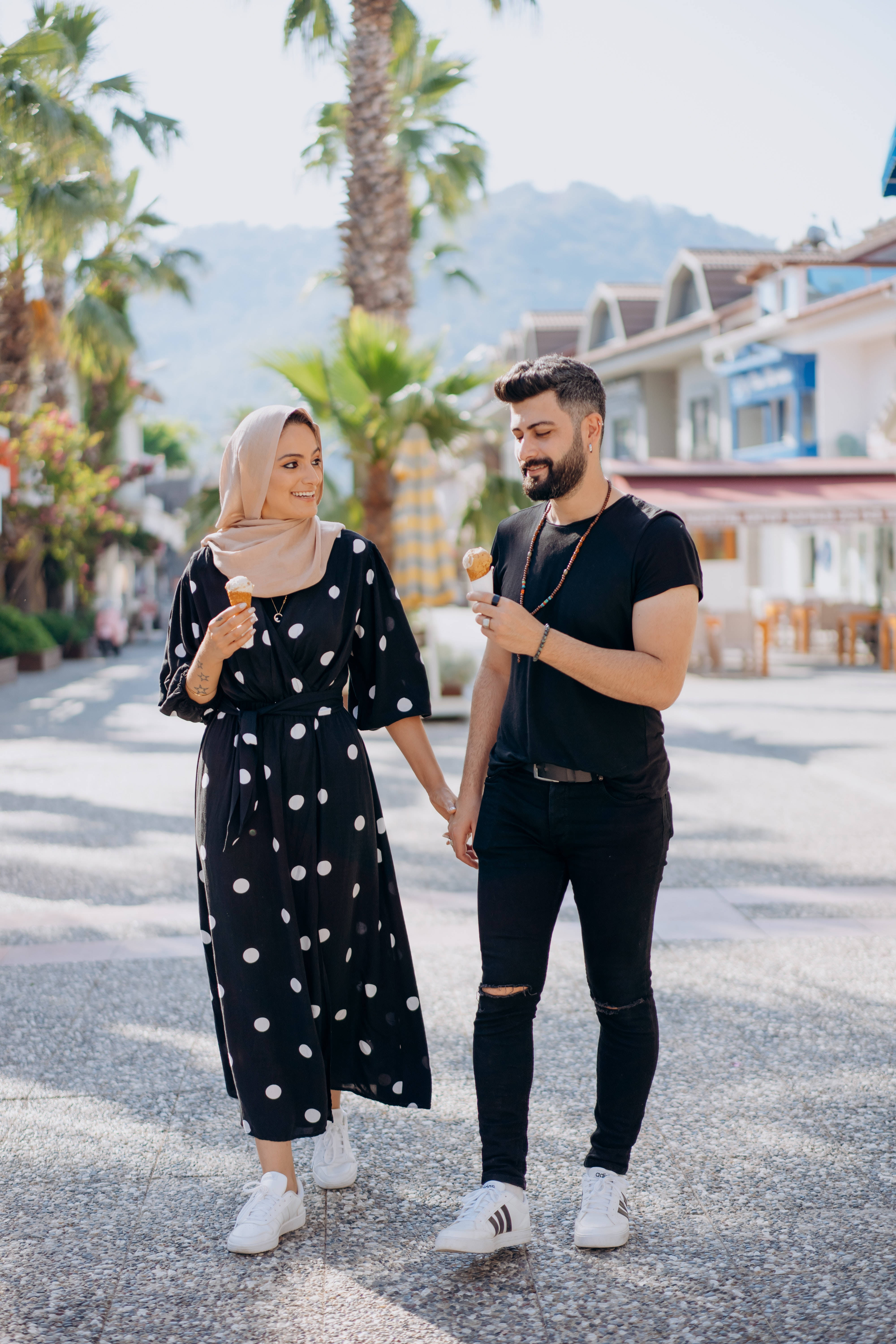 Muslim Couple, ice cream cones, sunlit palm-lined street, 5K Phone Wallpaper