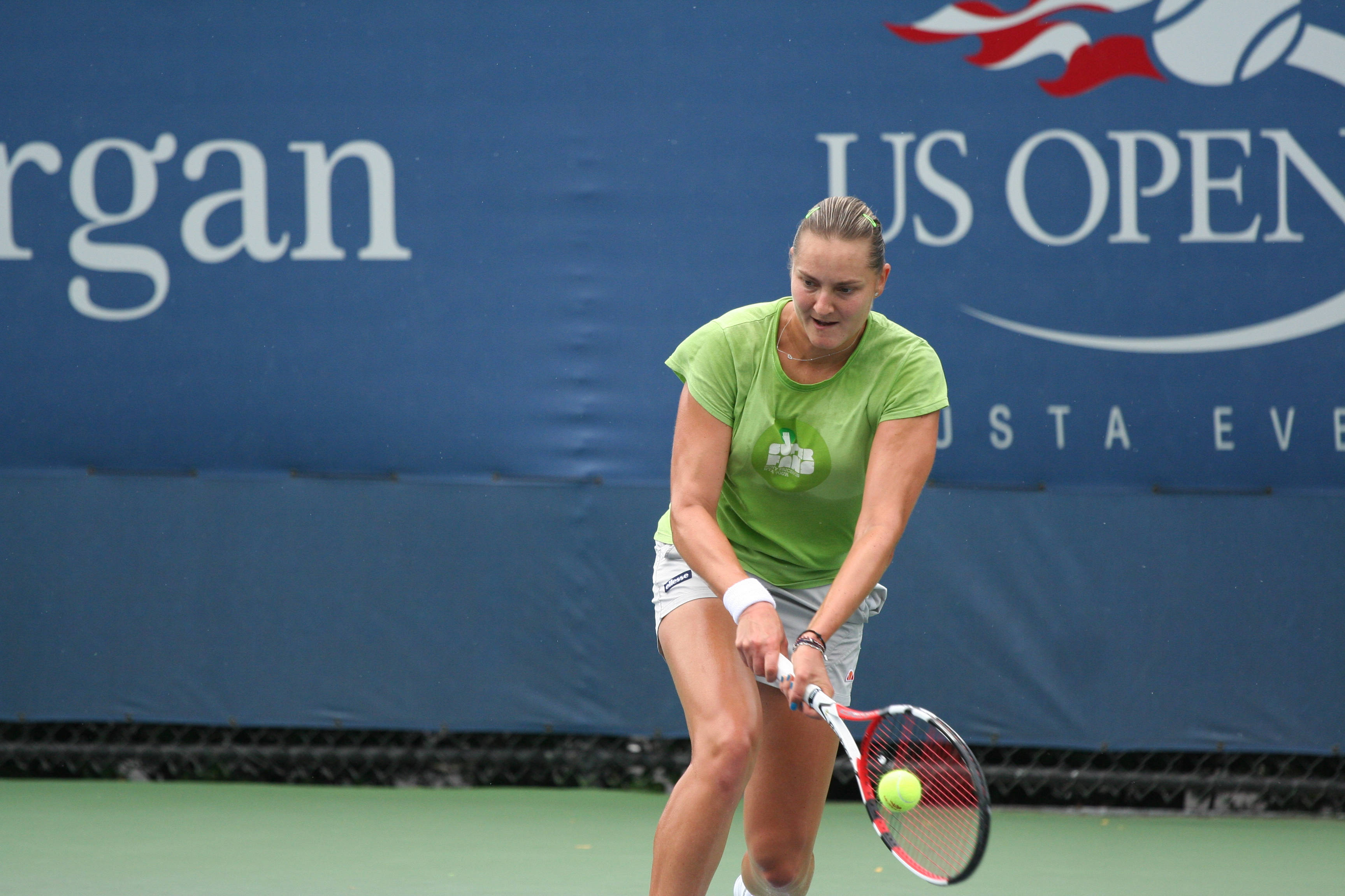 Nadia Petrova, low double-handed stroke, green shirt, 2K Desktop Wallpaper