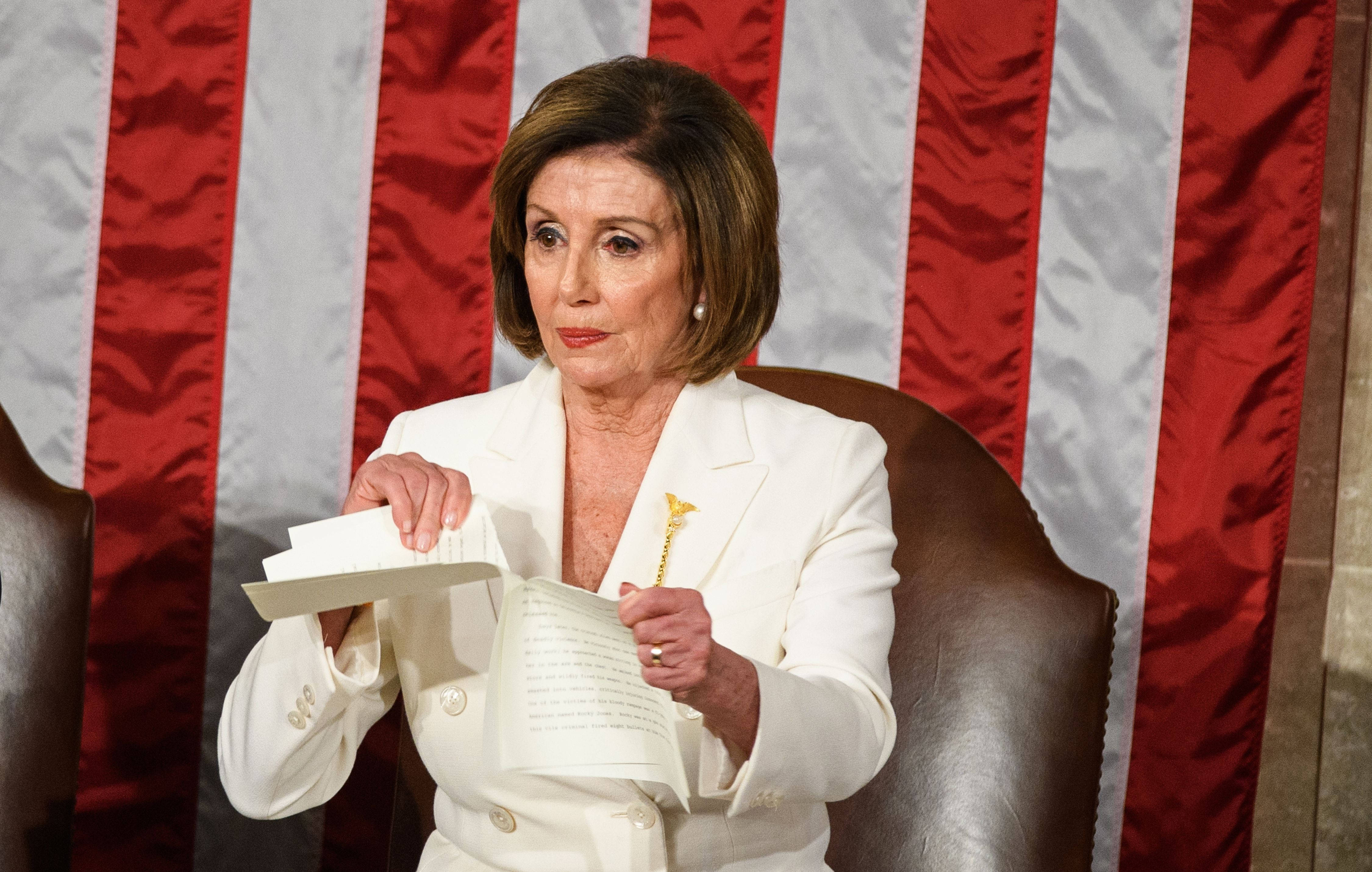 Nancy Pelosi, white suit, red and white striped American flag backdrop, 4K Desktop Wallpaper