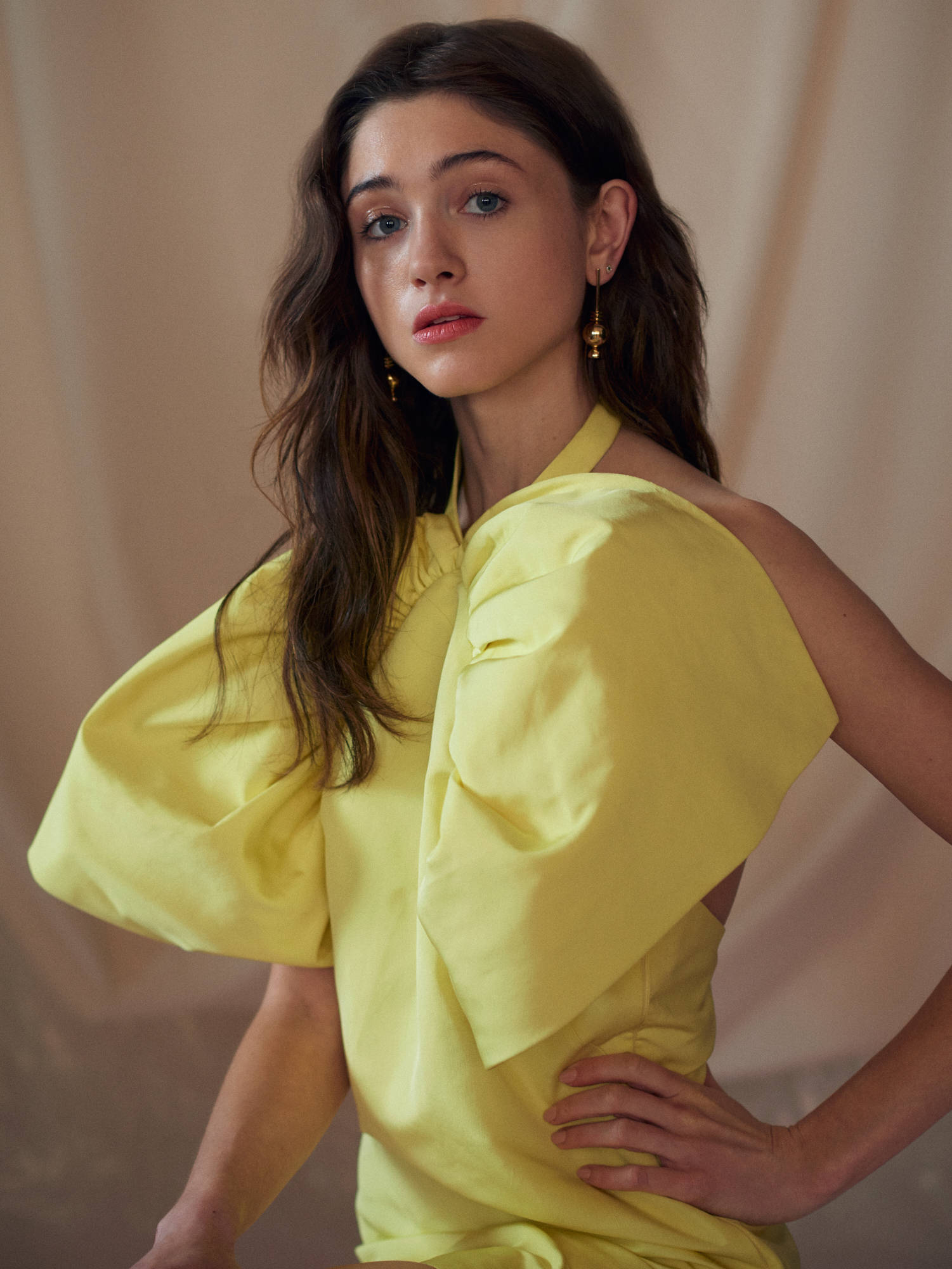 Natalia Dyer, vibrant yellow off-shoulder dress, long wavy hair, Full HD Phone Wallpaper
