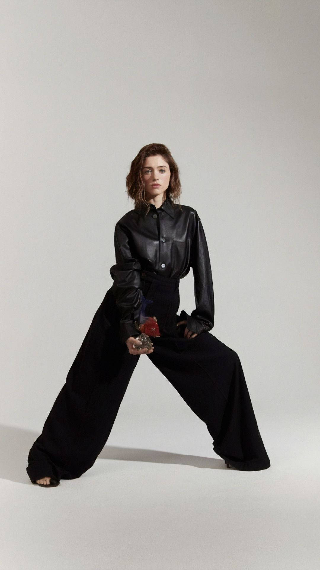 Natalia Dyer, black leather shirt, wide-leg pants, Full HD Phone Wallpaper