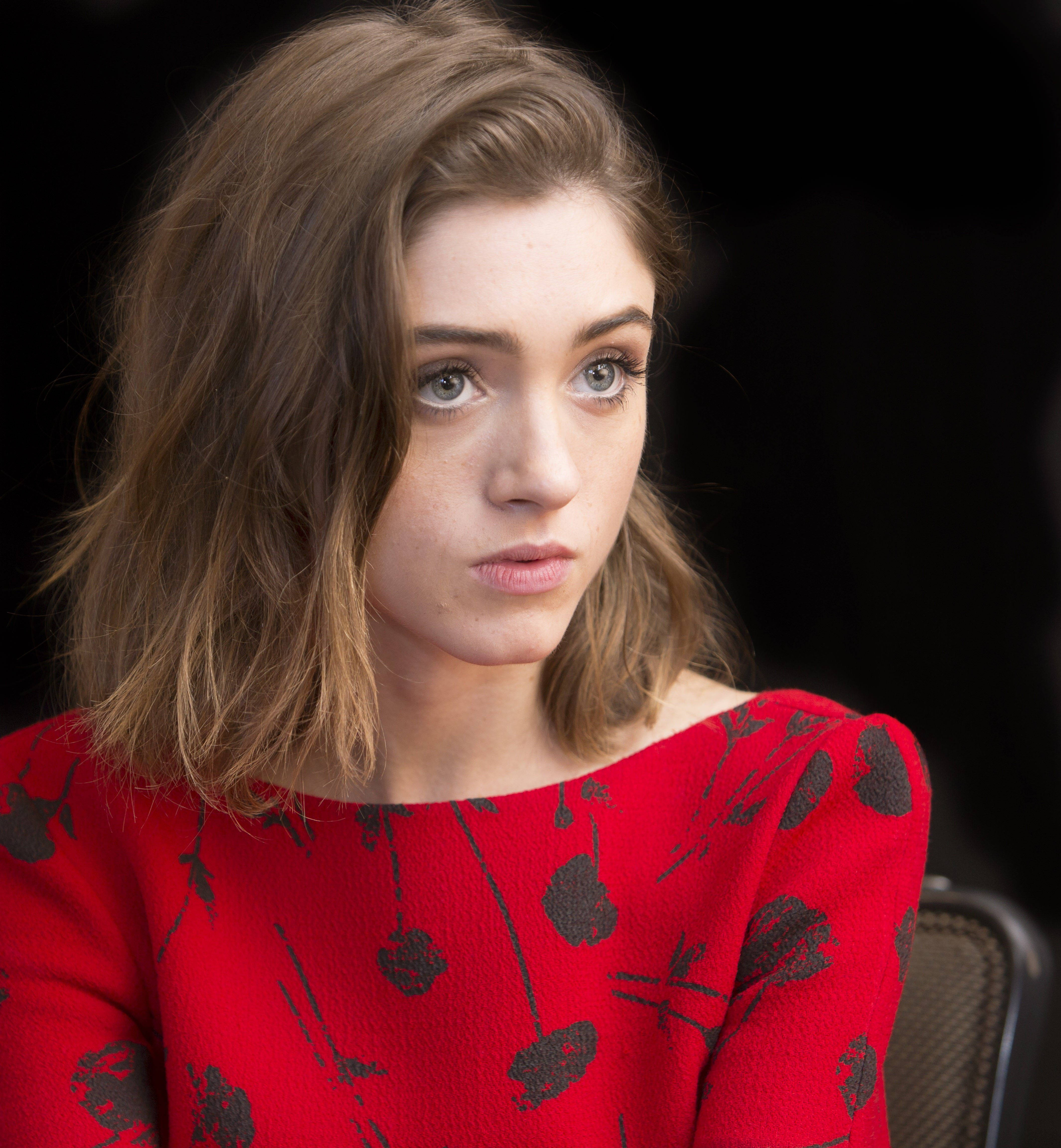 Natalia Dyer, tousled brown hair, striking green eyes, 4K Phone Wallpaper