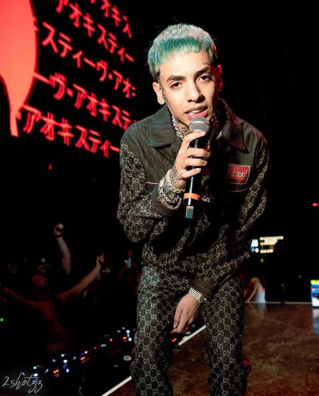 Natanael Cano, vibrant teal hair, dimly lit stage, SD Phone Wallpaper