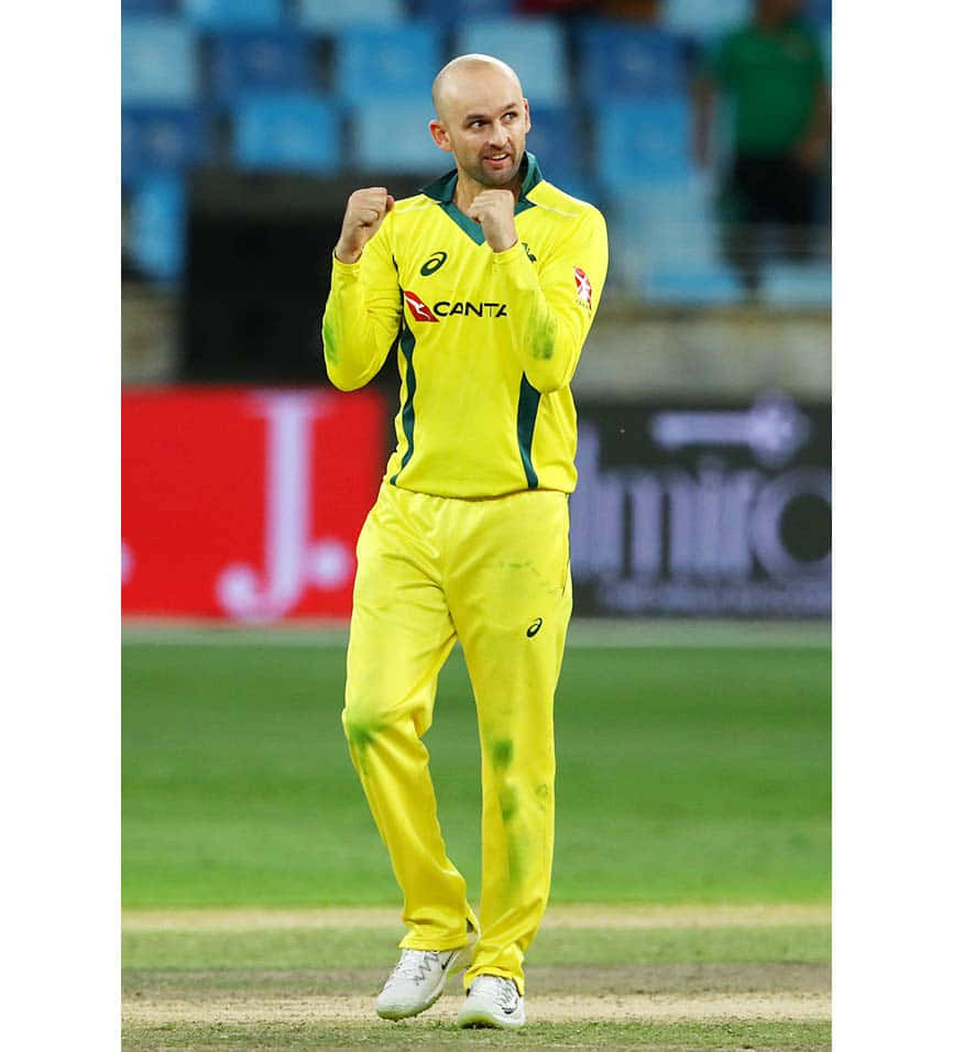 Nathan Lyon, bright yellow uniform, green field, SD Phone Wallpaper
