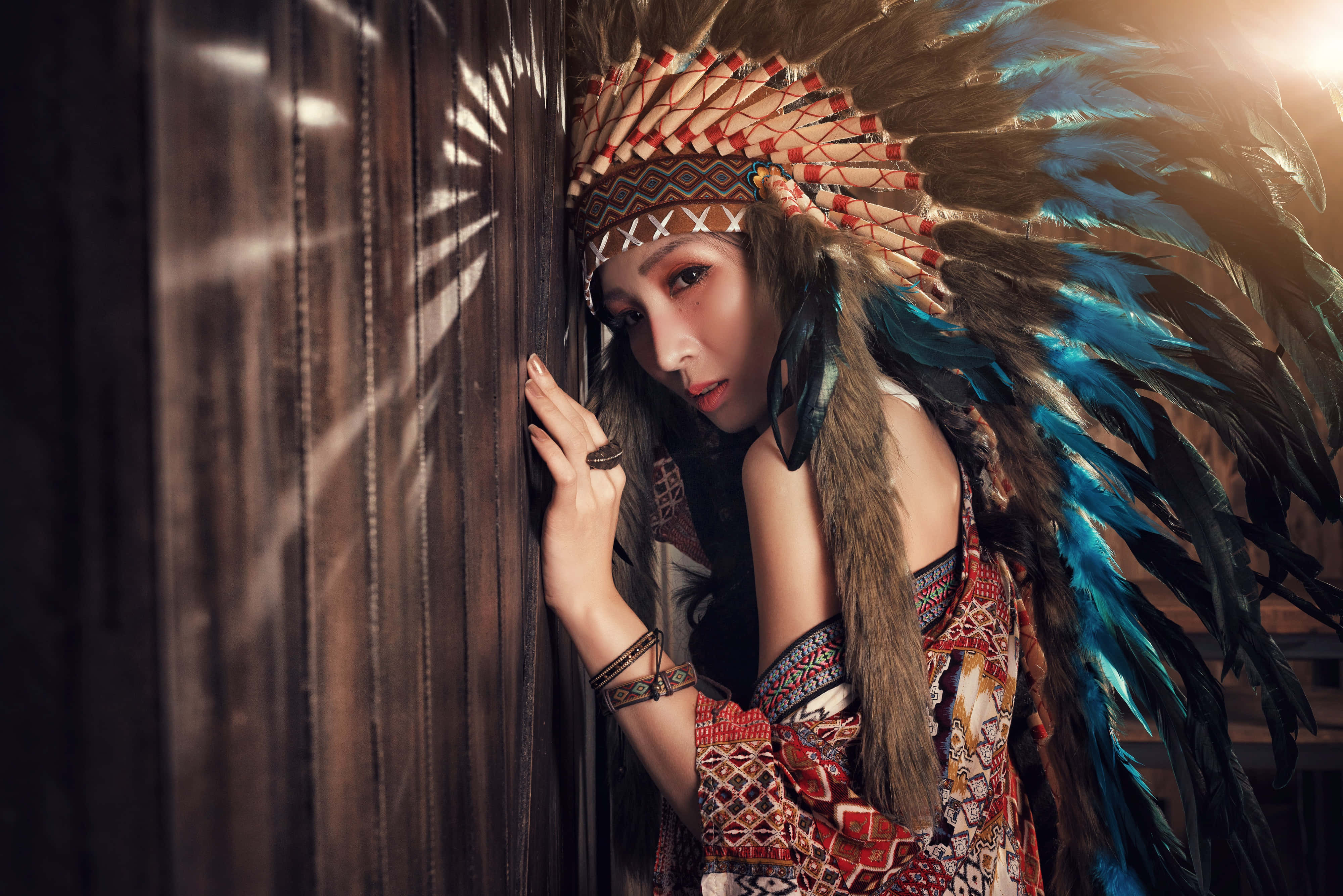 feathered headdress, wooden door, golden light, 4K Desktop Wallpaper