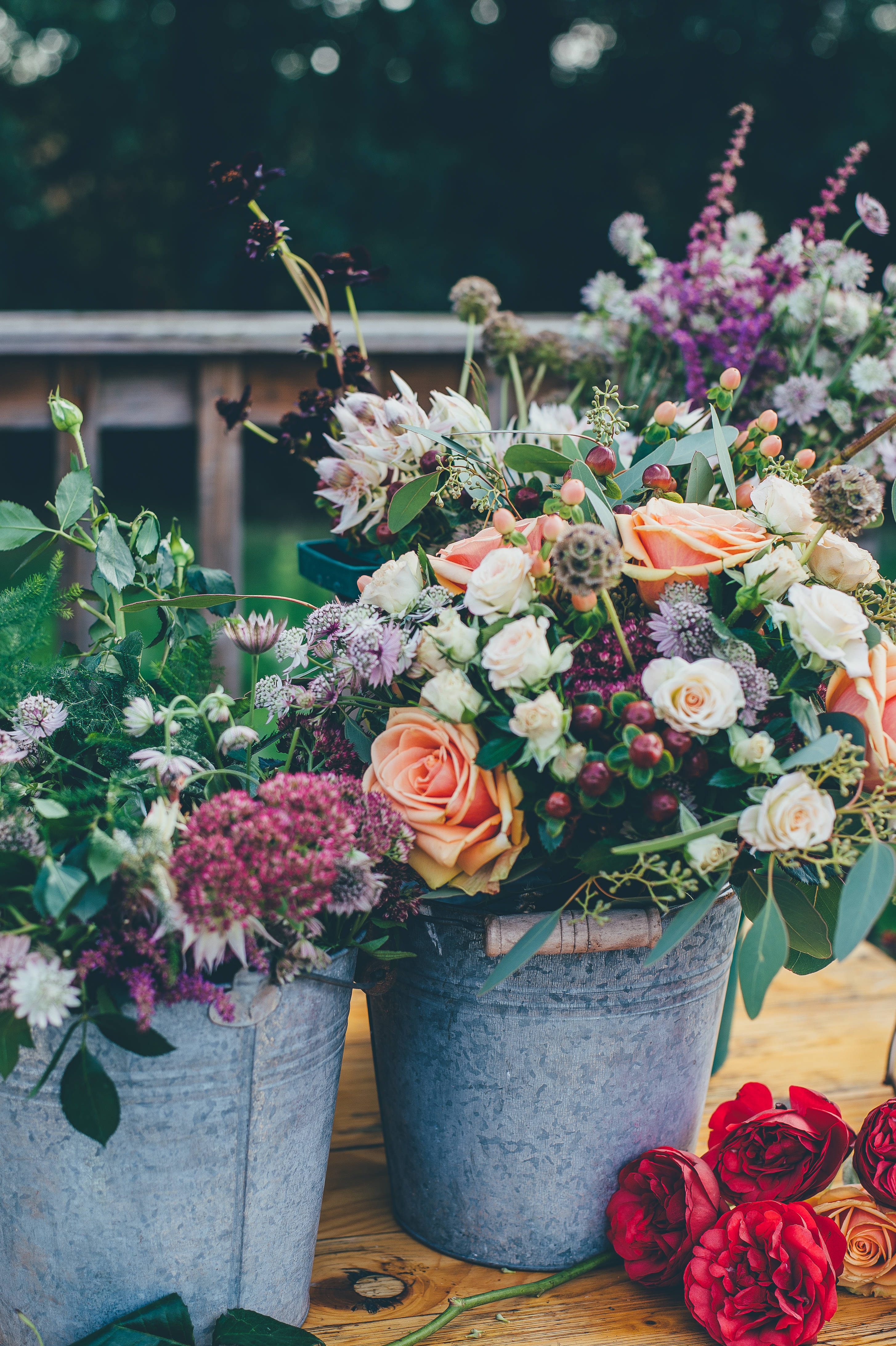galvanized buckets, peach white and purple flowers, wooden table, 4K Phone Wallpaper