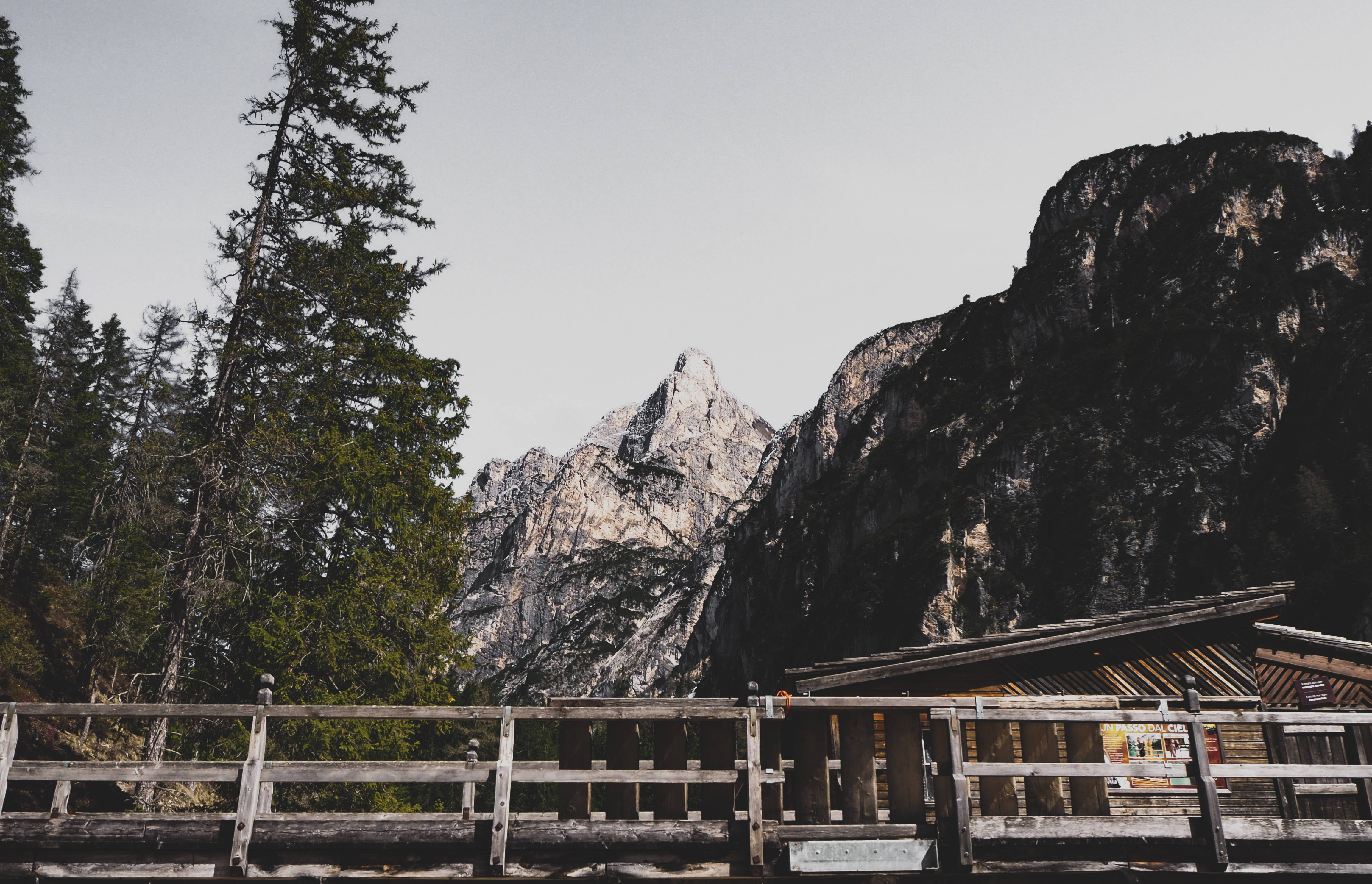 rustic wooden bridge, mountain lodge, towering evergreens, 4K Desktop Wallpaper