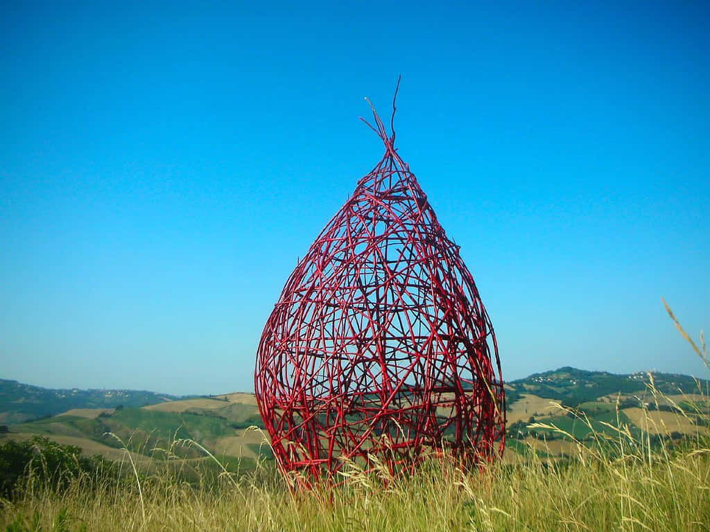 vibrant red wireframe teardrop sculpture, grassy hill, rolling green hills, SD Desktop Wallpaper