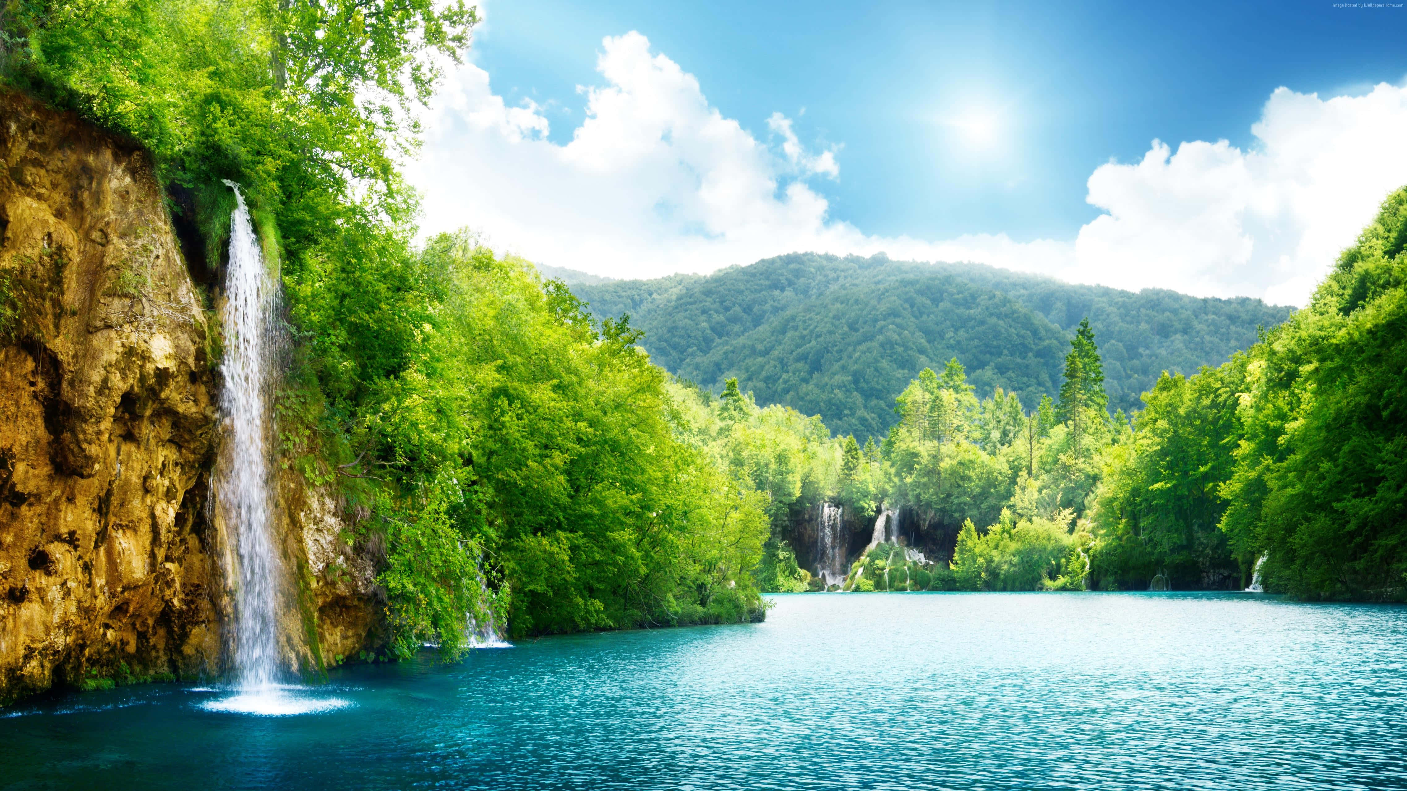 vibrant waterfall, turquoise lake, lush green forests, 4K Desktop Wallpaper