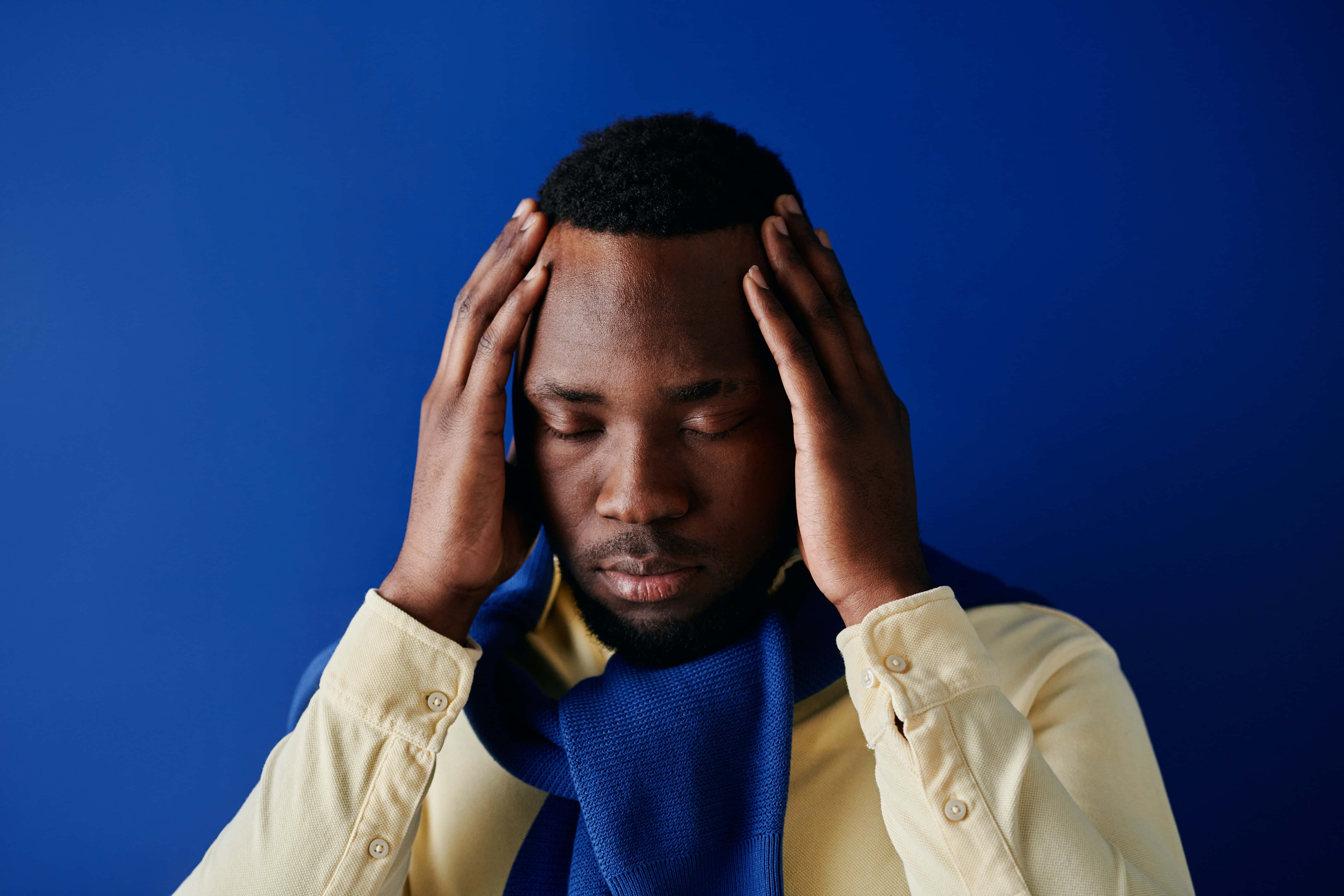 navy blue scarf, yellow shirt, solid blue background, 5K Desktop Wallpaper