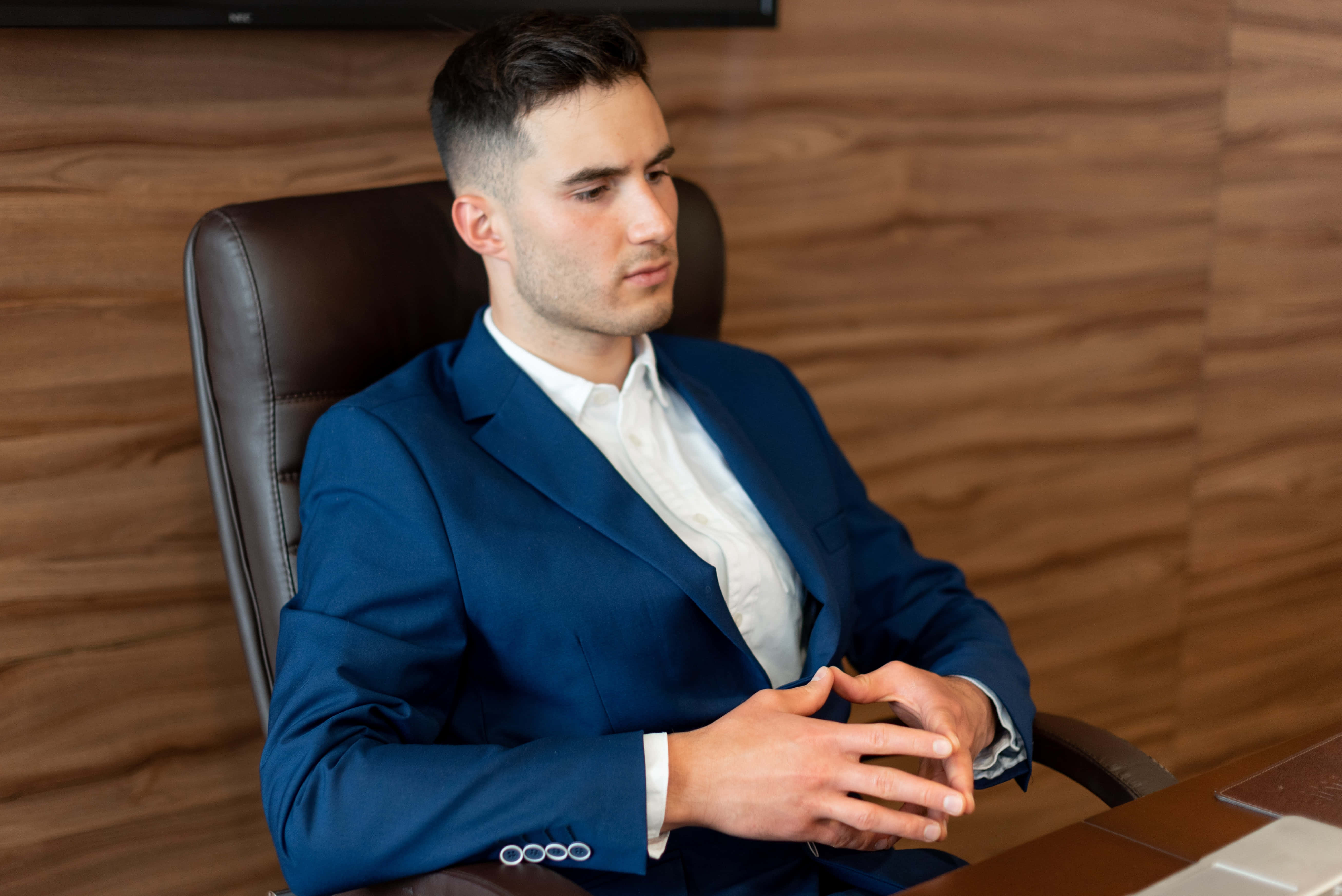 navy blue suit, leather chair, wood-paneled office wall, 5K Desktop Wallpaper