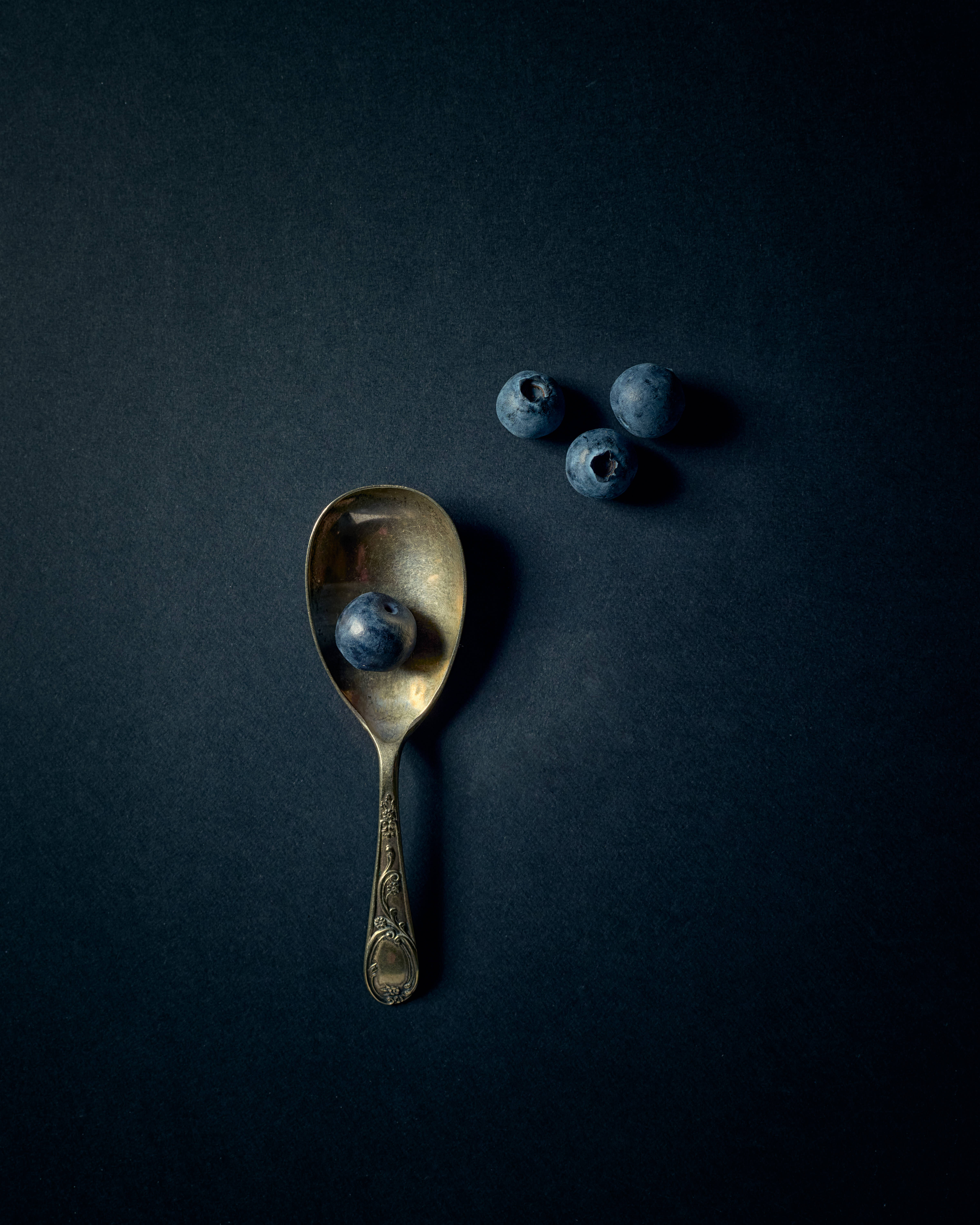 vintage silver spoon, blueberry, deep navy textured surface, 5K Phone Wallpaper