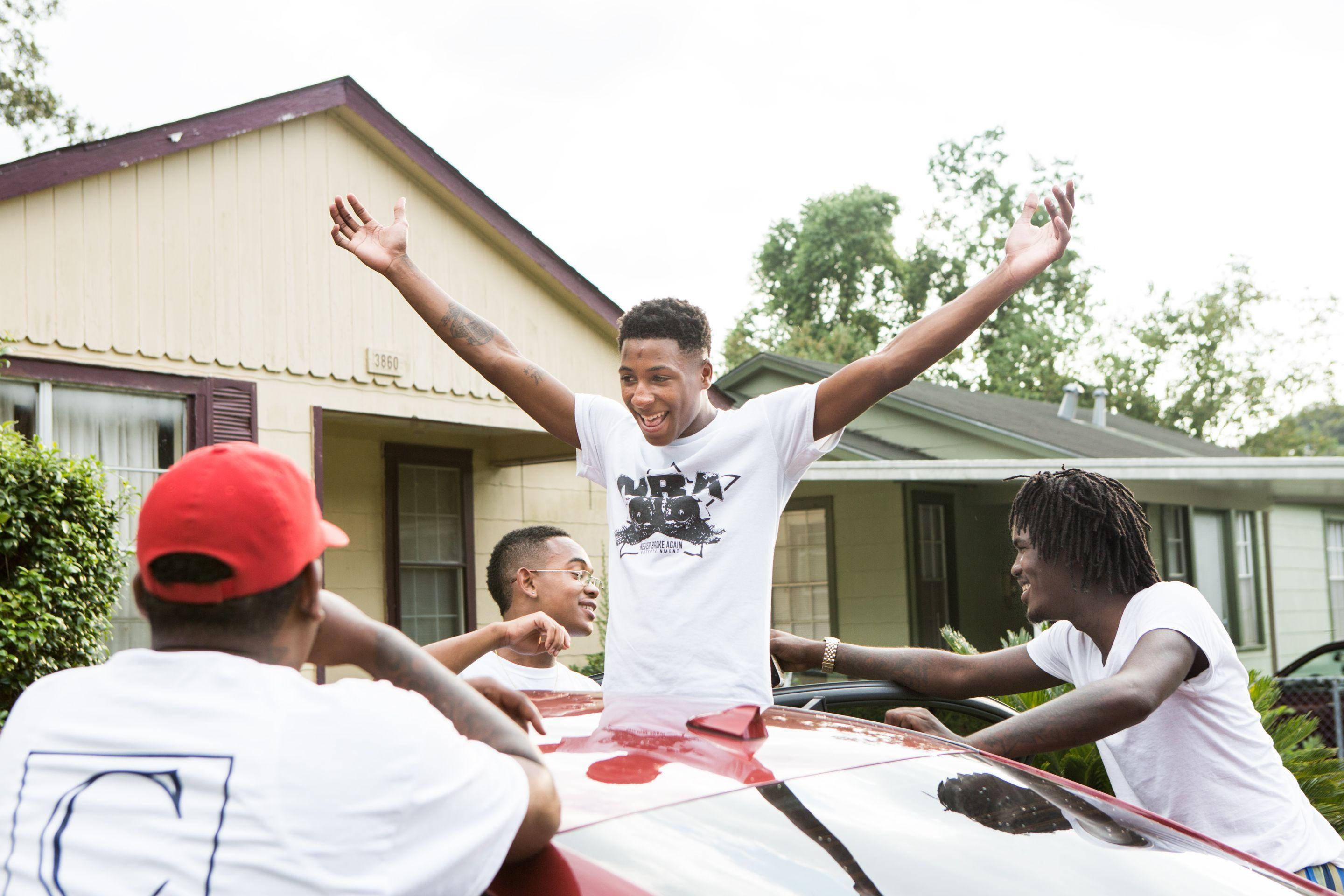 NBA Youngboy, red car hood, suburban neighborhood, 2K Desktop Wallpaper