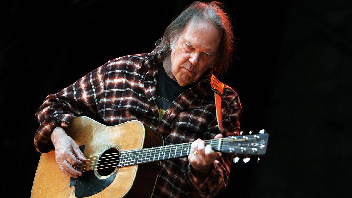 Neil Young, acoustic guitar, dramatic stage lighting, SD Desktop Wallpaper