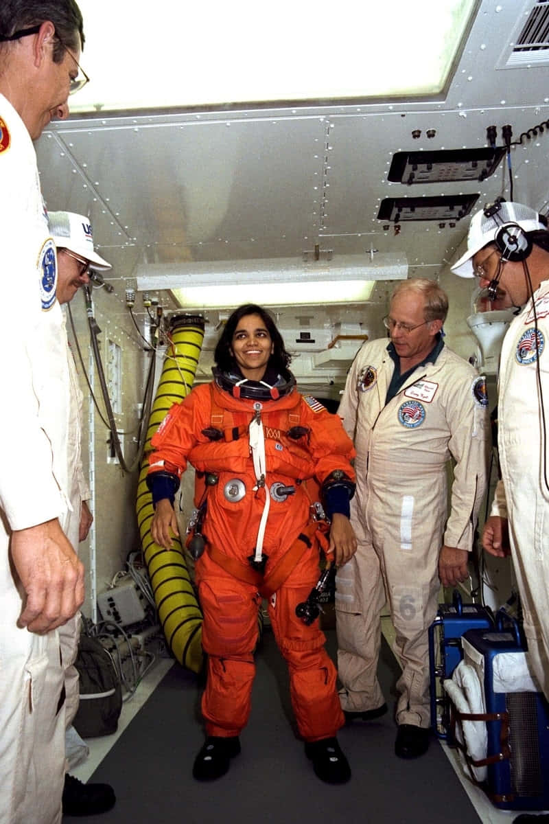 Astronaut, orange space suit, cramped spacecraft corridor, SD Phone Wallpaper